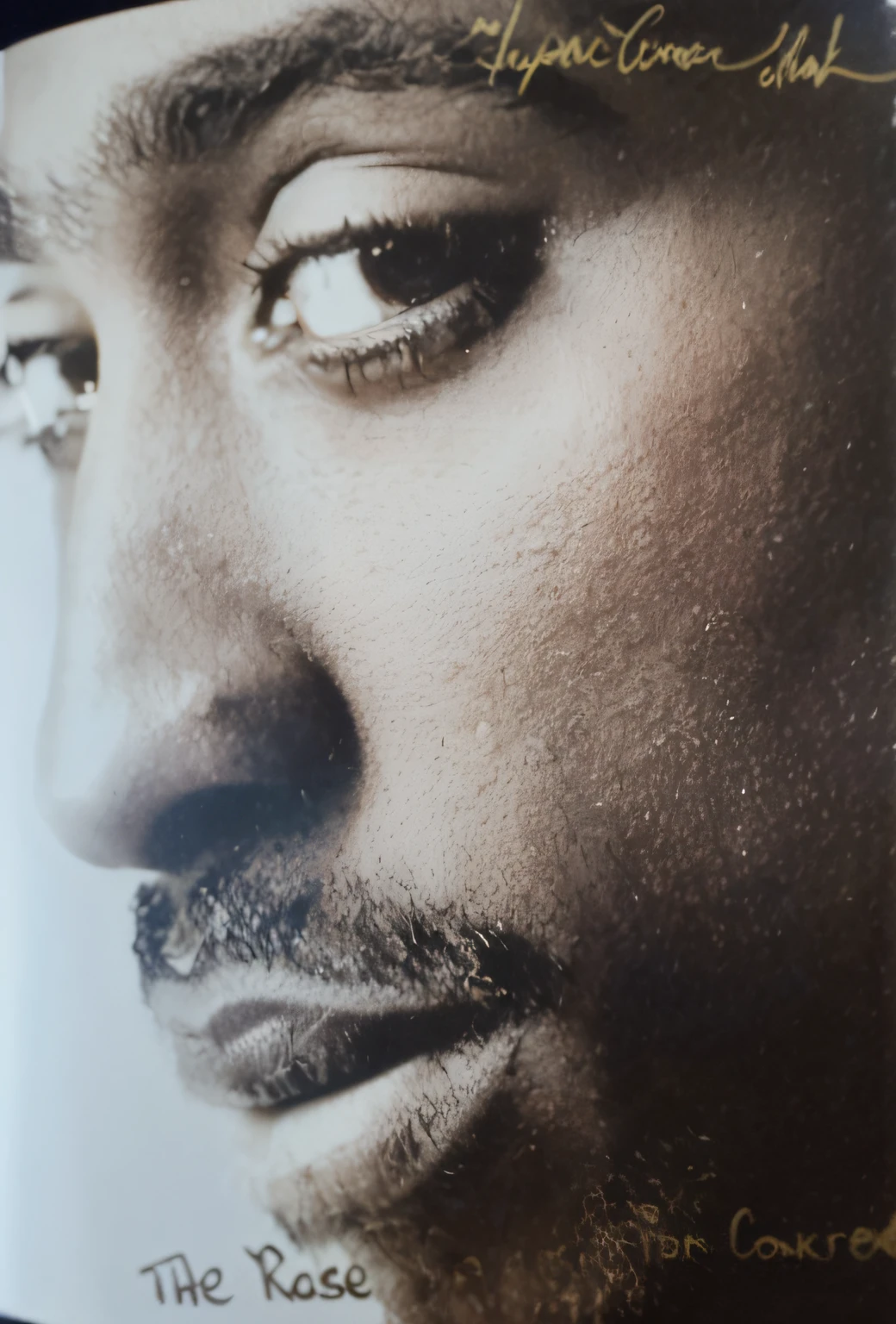 a close up of a book with a picture of a man's face, 8k resolution. tupac, tupac shakur, tupac, masterpice, close up portrait shot, art masterpice, closeup portrait shot, taken in the early 2020s, close up portrait, taken in 1 9 9 7, close - up portrait shot, portrait close up