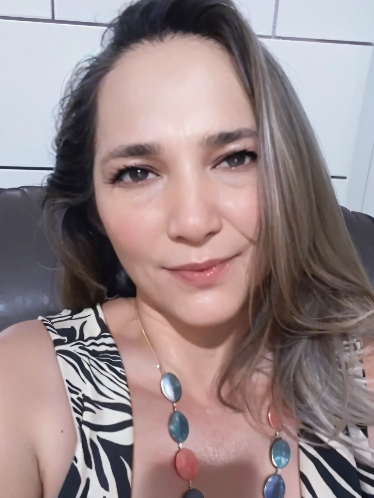 there is a woman sitting on a couch with a necklace on, Directed by: Nandor Soldier, imagem de perfil, 3 5 year brazilian mother, fernanda suarez, 4 5 I, Malika Favre, Ayahausca, Anos Imane, Foto realista, imagem frontal, inspirado em Maria Helena Vieira da Silva, Sandra Chevier