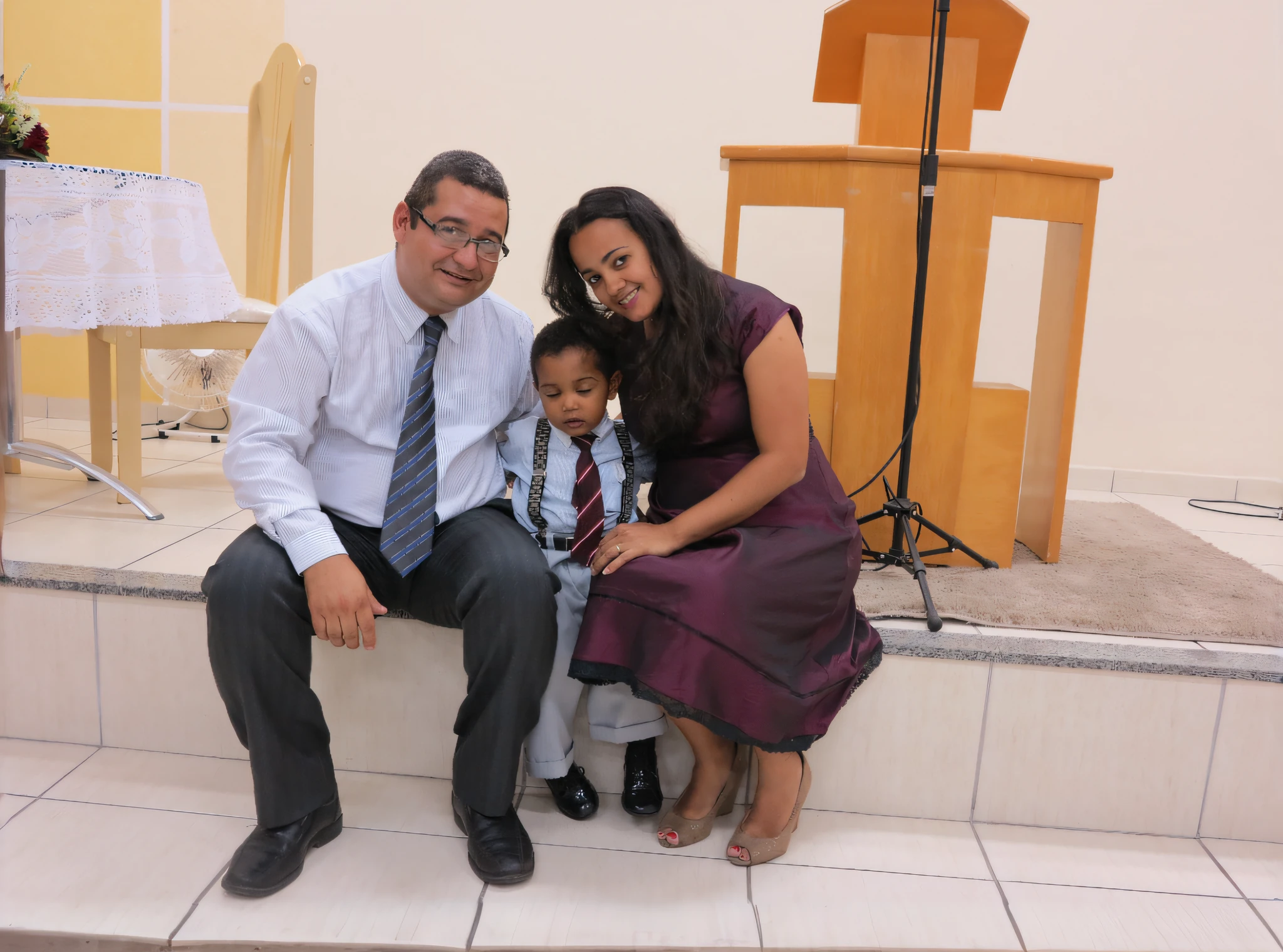 There is a man and a woman sitting on a bench with a child, na igreja, marido esposa e filho, divertindo-se, taken in the night, Happy family, batismo, Postagem 4k, 4 k post, full body photgraph, Directed by: Siona Shimshi, Family photo, foto do perfil, slight cloudy lighting, cabrito, Nilo, with a kid