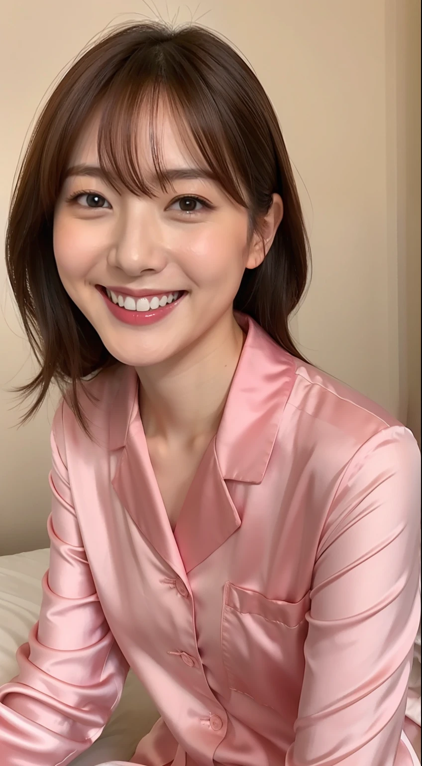 Japan woman in silk pink pajamas is sitting on bed and smiling,