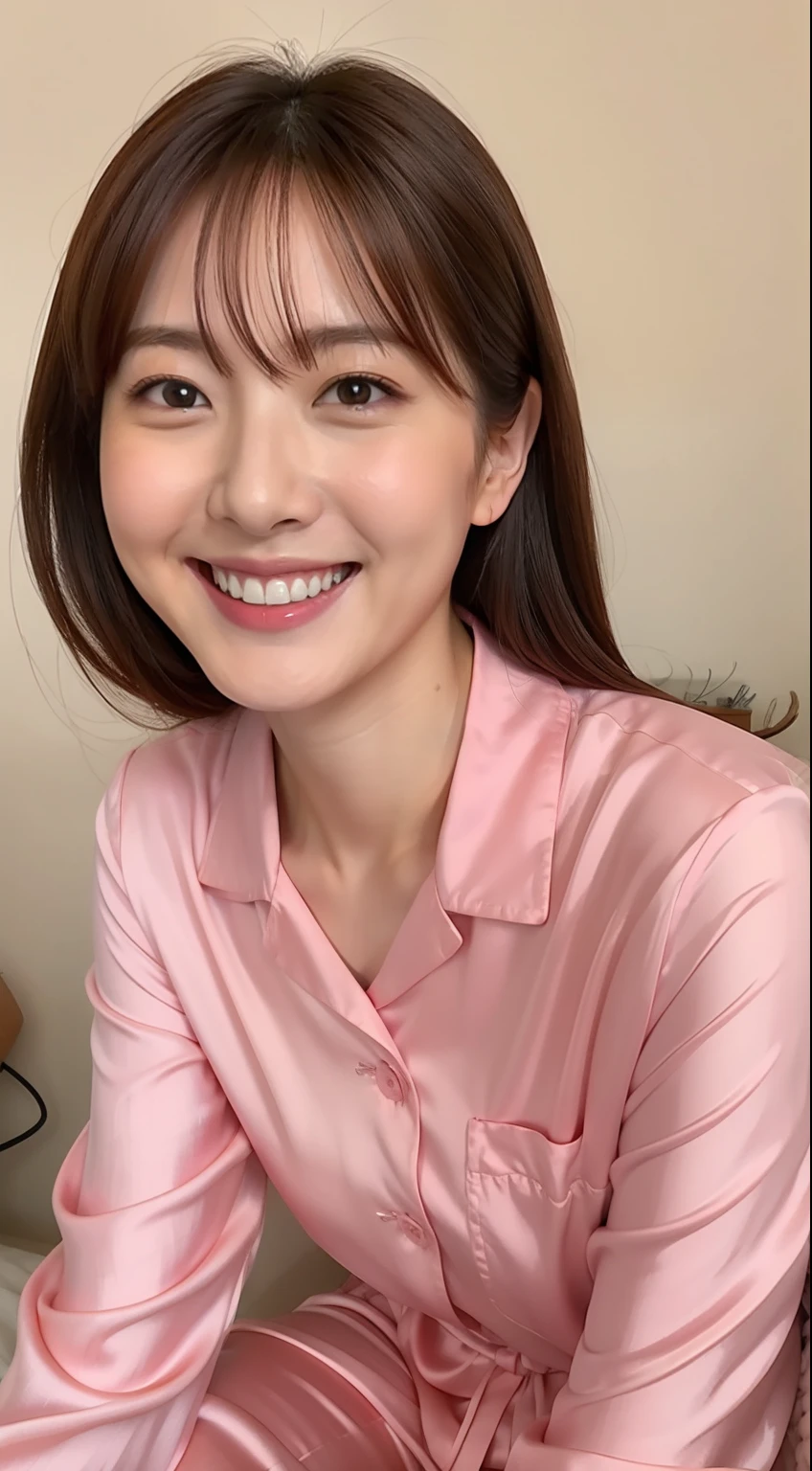 Japan woman in silk pink pajamas is sitting on bed and smiling,