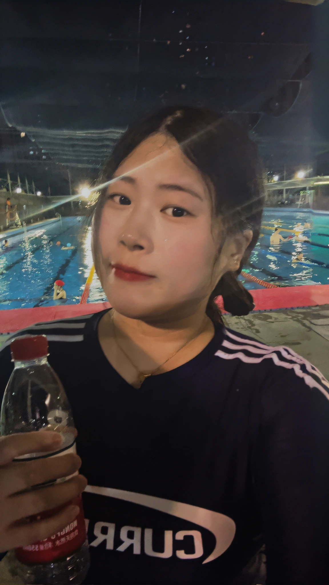 there is a woman holding a bottle of water in front of a swimming pool, wenfei ye, 2 7 years old, profile pic, xintong chen, taejune kim, 2 8 years old, Swimming, 3 2 - year - old, 2 9 years old, photograph taken in 2 0 2 0, jiyun chae, in a swimming pool, next to a pool