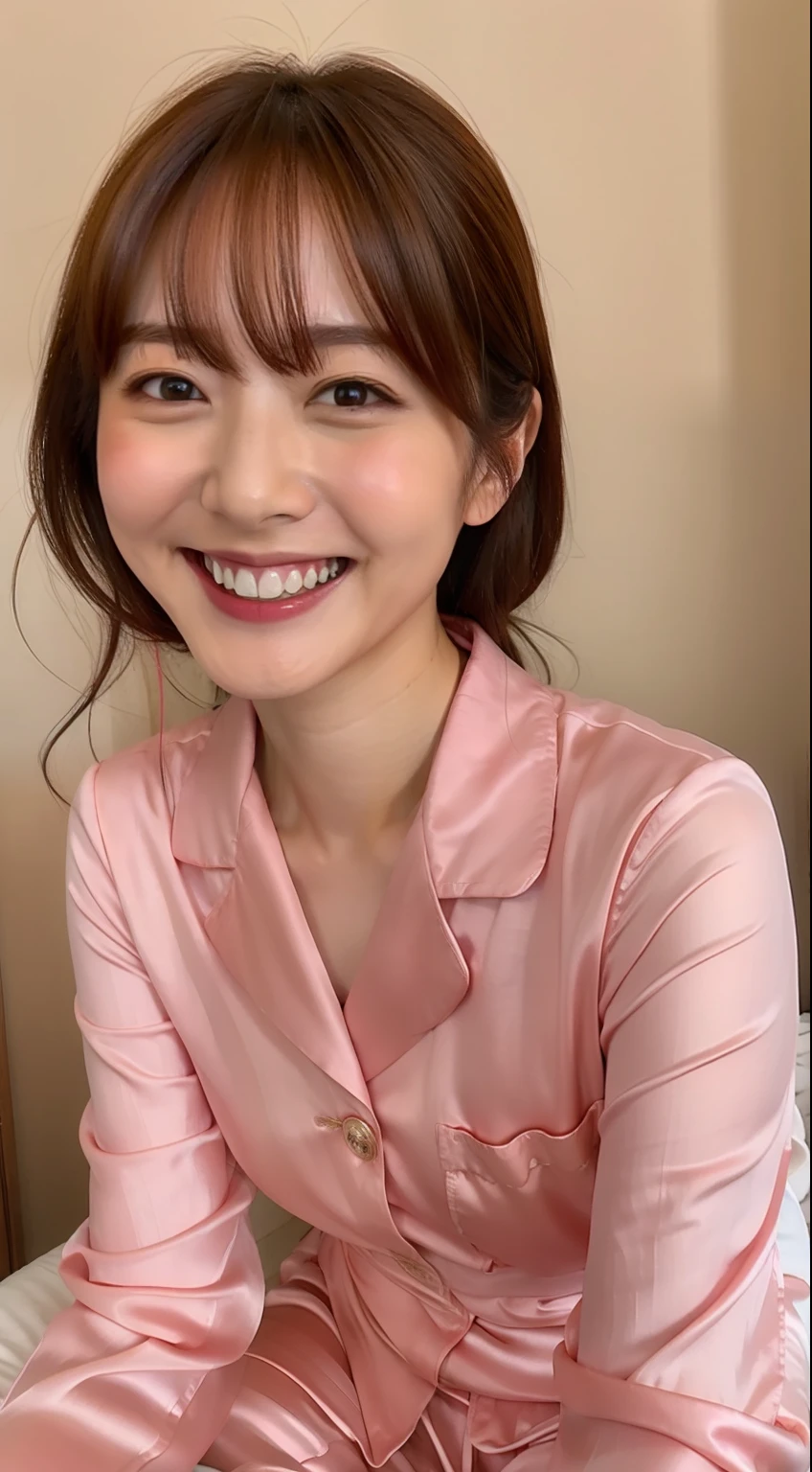 Japan woman in silk pink pajamas is sitting on bed and smiling,