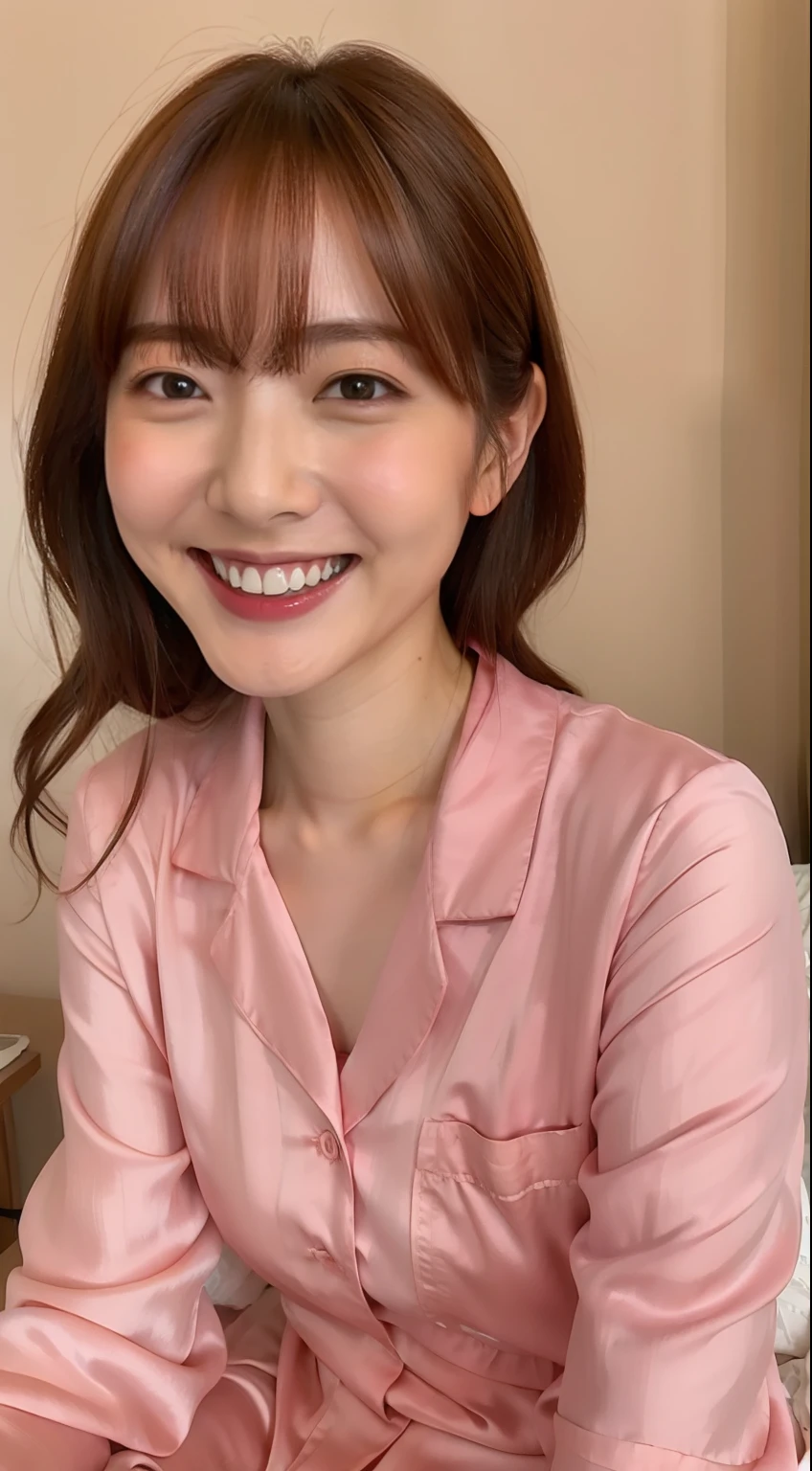 Japan woman in silk pink pajamas is sitting on bed and smiling,