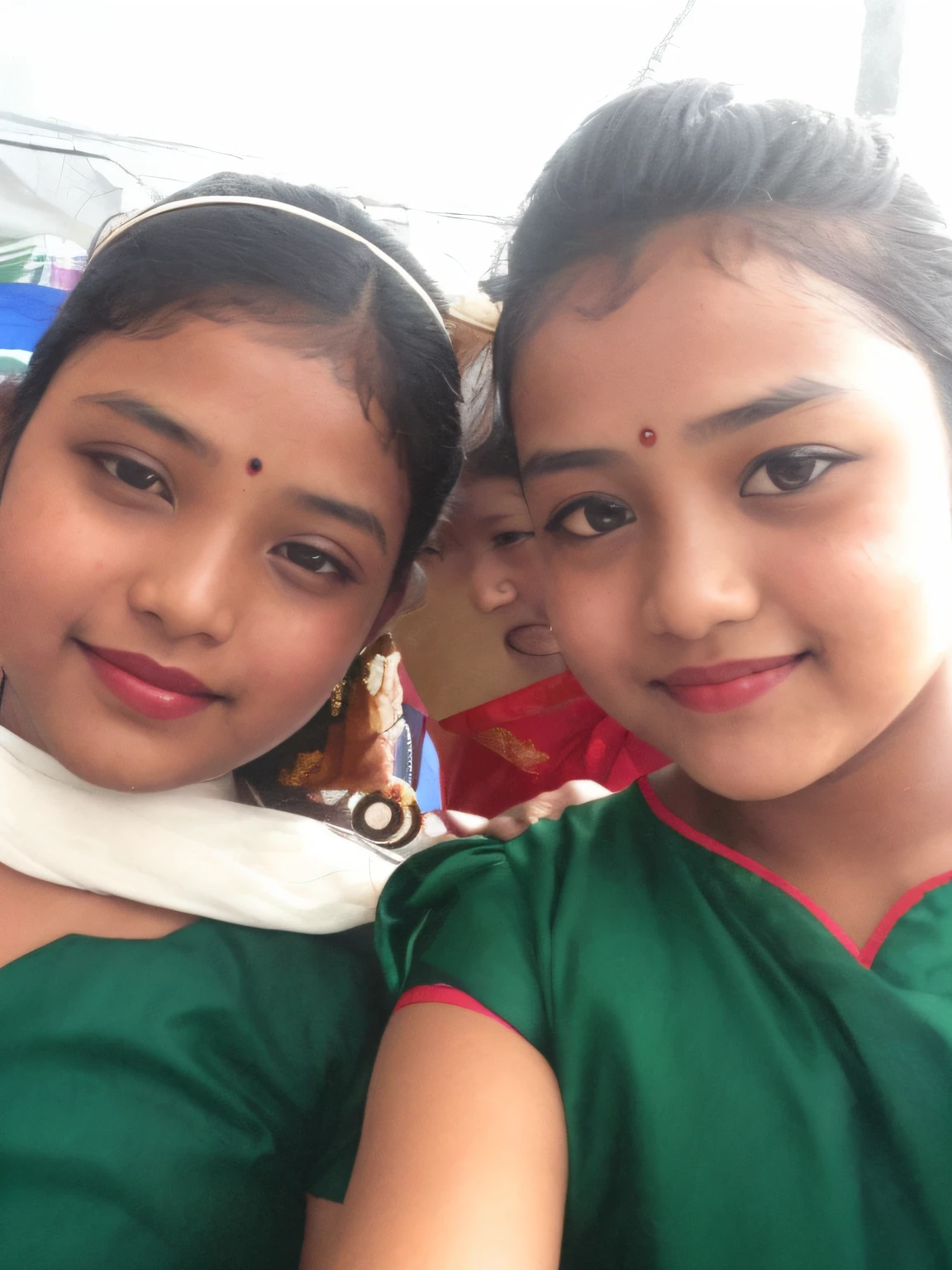there are two girls that are posing for a picture together, wearing bihu dress mekhela sador, wearing traditional garb, with lovely look, assamese, both have red lips, two girls, beautiful girls, taken with the best dlsr camera, very very low quality picture, selfie!!!!!, beautiful faces, not blurry, with wet faces!!