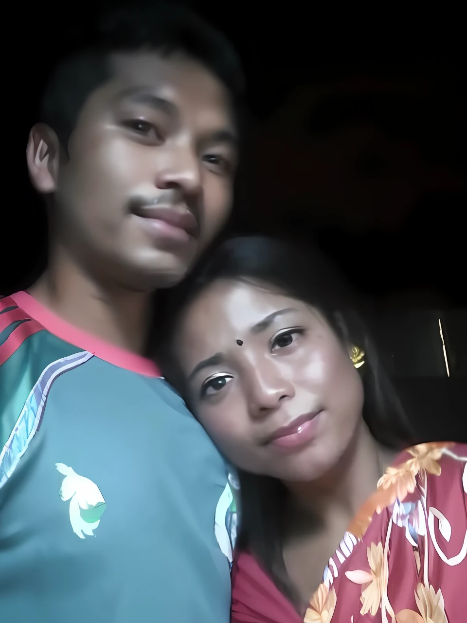 there are two people standing together in a dark room, lovely couple, couple, very very low quality picture, assamese, couple pose, very clear picture, happy couple, with lovely look, old picture, a picture, selfie photo, picture, wife, profile pic, in love selfie, selfie!!!!!, very very beautiful, ayan nag, candid picture