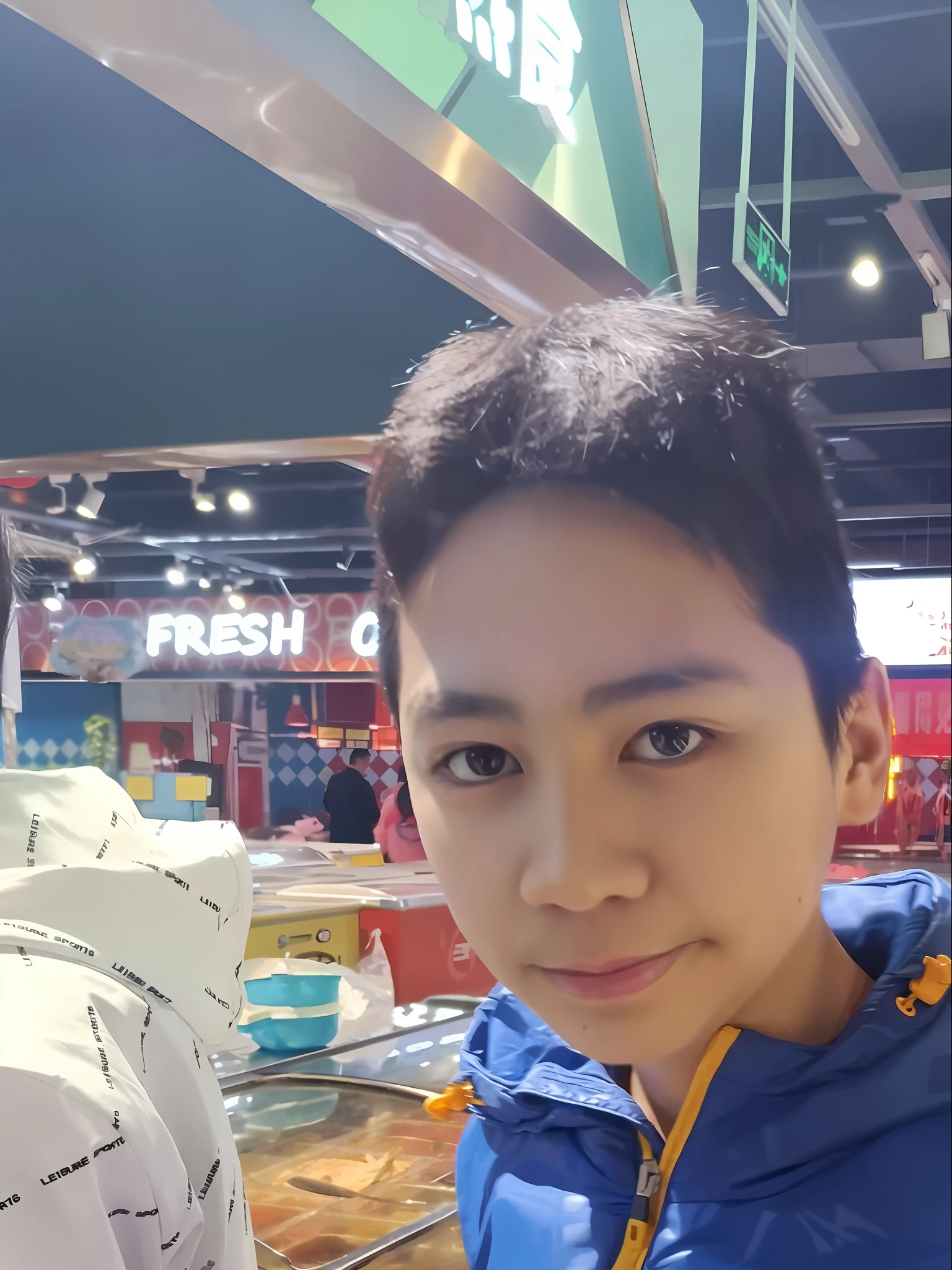 there is a man that is holding a cell phone in his hand, appearing in a shopping mall