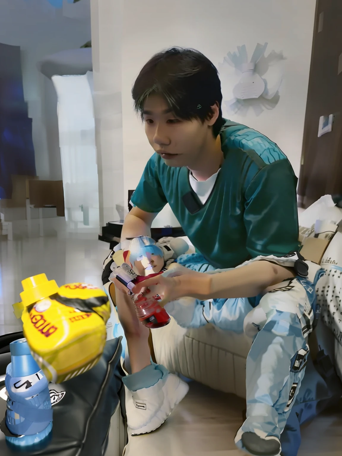 There was a young man sitting on the sofa，Holding a bottle of water in his hand, taken with sony alpha 9, taken with a Sony A7R camera, taken with canon 8 0 d, shot on nikon z9, shot on nikon d 3 2 0 0, Photo taken with Nikon D 7 5 0, Photo taken with Nikon D750, wearing nike air mags