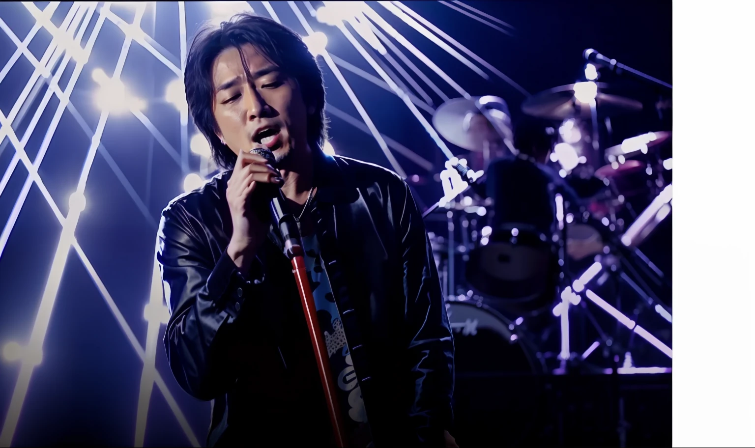 Video of a man singing with a microphone stand。blue tone。Hiroshi Inaba of B'z。