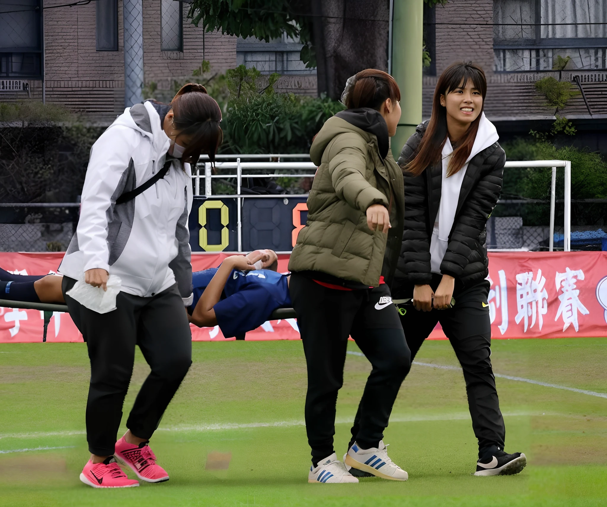 a soccer scene in a chinese sports stadium, rainy weather, wet ground, rainfall, injury scene in a sports stadium, stretcher carry, there are four female medics in wet raincoats who carrying a stretcher, there are four female medics in wet raincoats who are carrying a stretcher in a rainy sports stadium, there is a wounded male soccer player in a matte short cotton sports outfit lying on the stretcher, an injured male soccer player is lying on his back on a stretcher and is rearing up in agony, a soccer player is rearing up in pain while lying on his back on a stretcher, dramatic scene, theatralic posing scene, dramatic pity scene, injury soccer, first aid, help, pity, there are four female medics in shiny raincoats who are looking very sad and very terrified and very shocked, the injured soccer player is screaming out in pain while he is carried from the pitch on a stetcher through the rain