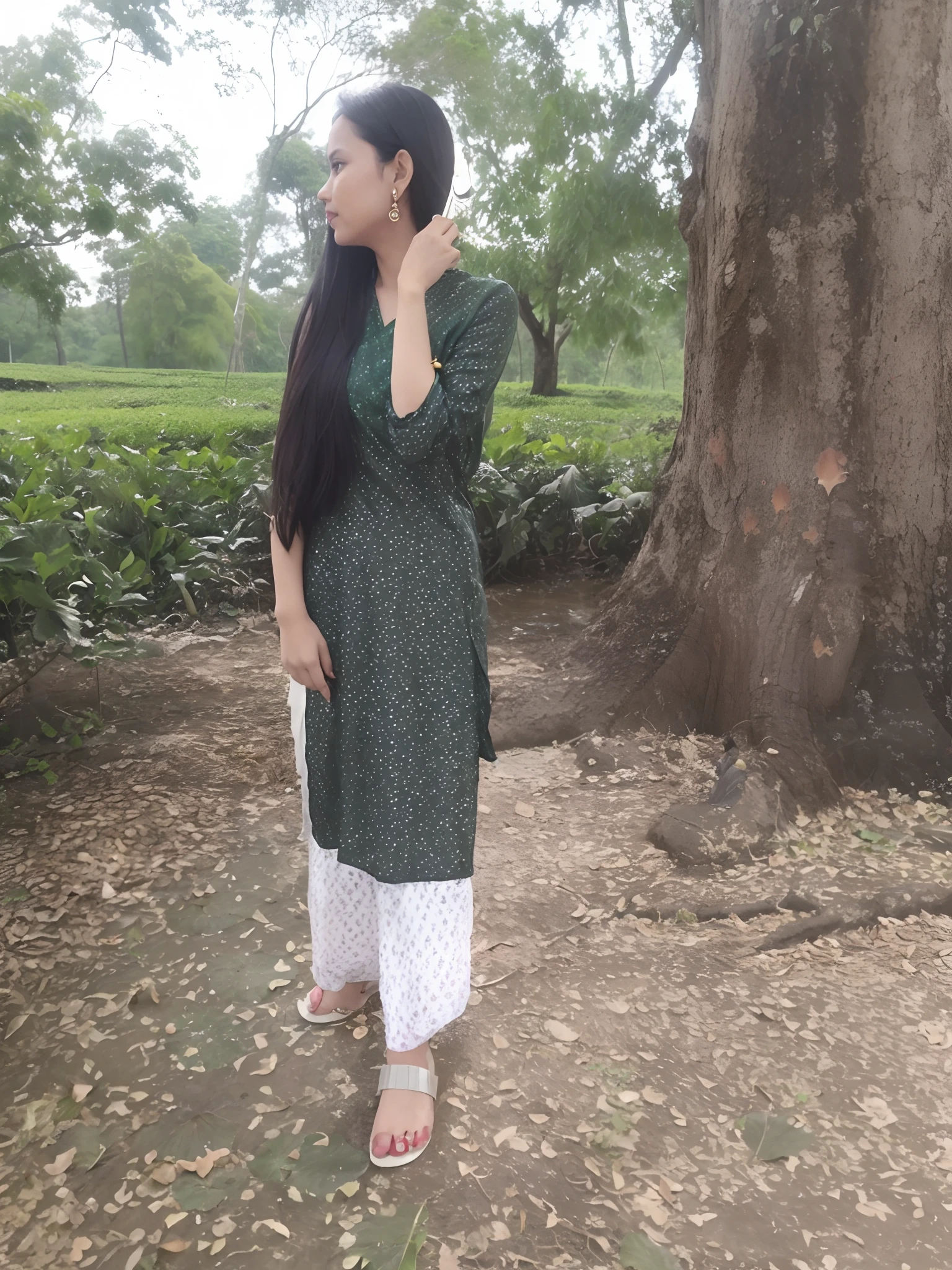 there is a woman standing in front of a tree talking on a cell phone, assamese aesthetic, wearing a kurta, wearing a silk kurta, wearing an elegant tribal outfit, green tunic, inspired by Puru, distant full body view, assamese, desi, * colour splash *, indian style, traditional beauty, standing gracefully upon a lotus