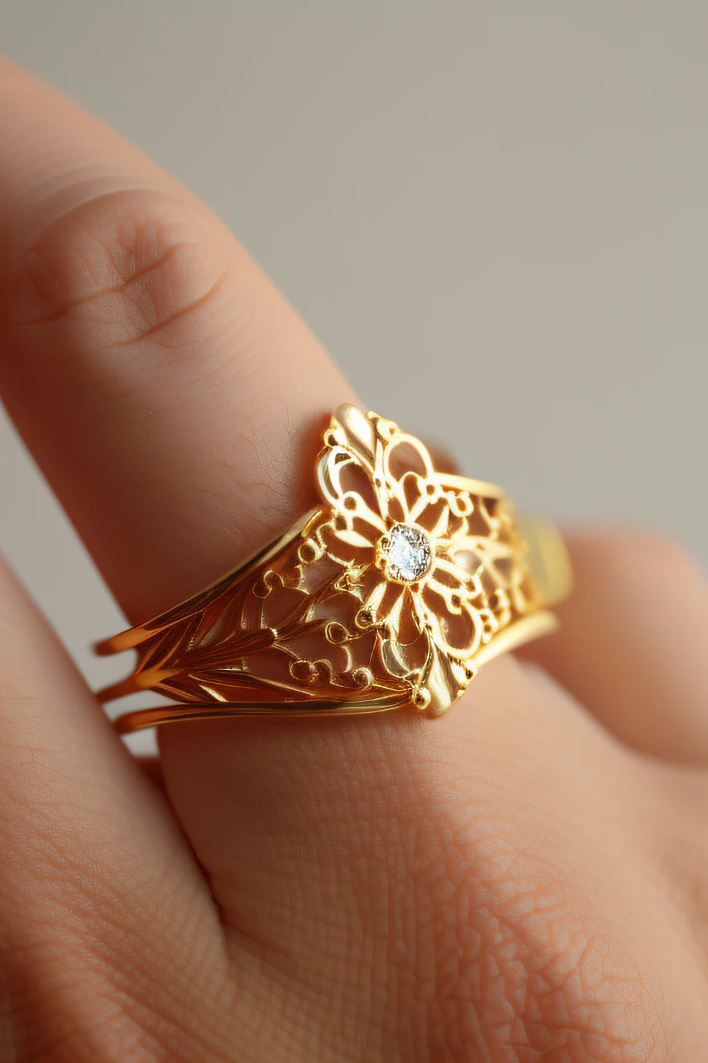 Yellow gold ring with openwork filigree white background