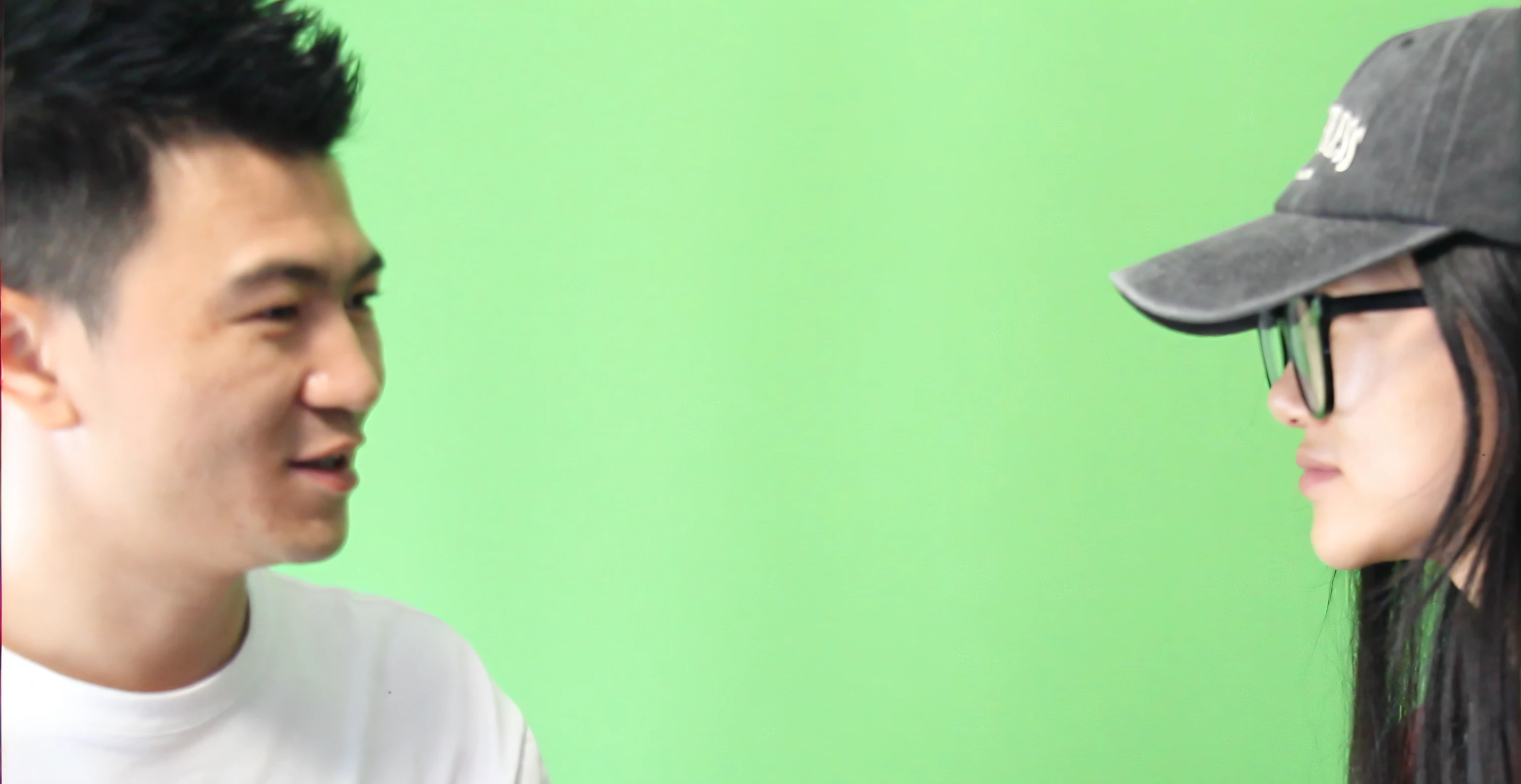 They looked at each other as they spoke, Green screen, behind the scenes photo, wearing sunglasses and a cap, green screen background, Commercial shooting, photo from a promo shoot, looking to the side off camera, production still, photoshoot, Be interviewed, music video, looking away from camera, Visual effects shots, wearing a baseball hat, still from a music video