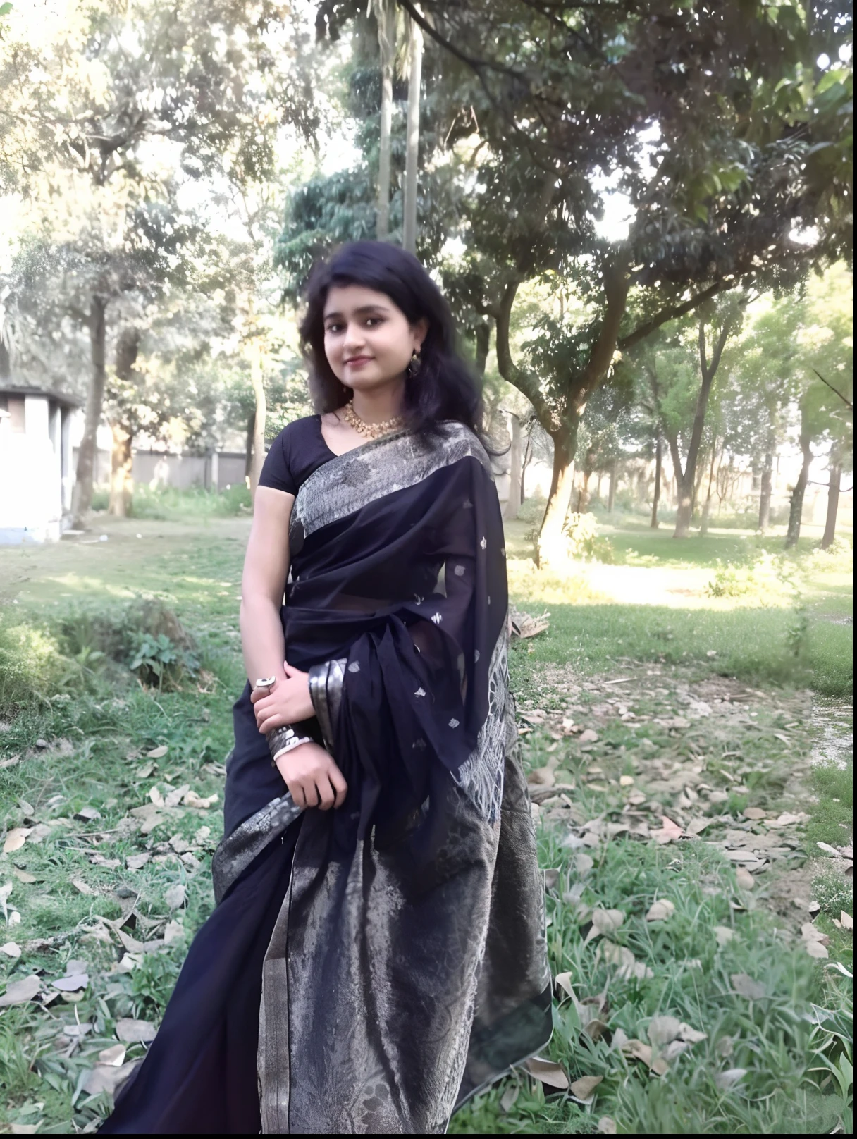 a woman in a black sari standing in a park, assamese aesthetic, assamese, with lovely look, wearing bihu dress mekhela sador, traditional beauty, candid picture, with a beautifull smile, dressed in a sari, very beautiful girl, around 1 9 years old, wearing sari, wearing a sari, profile picture