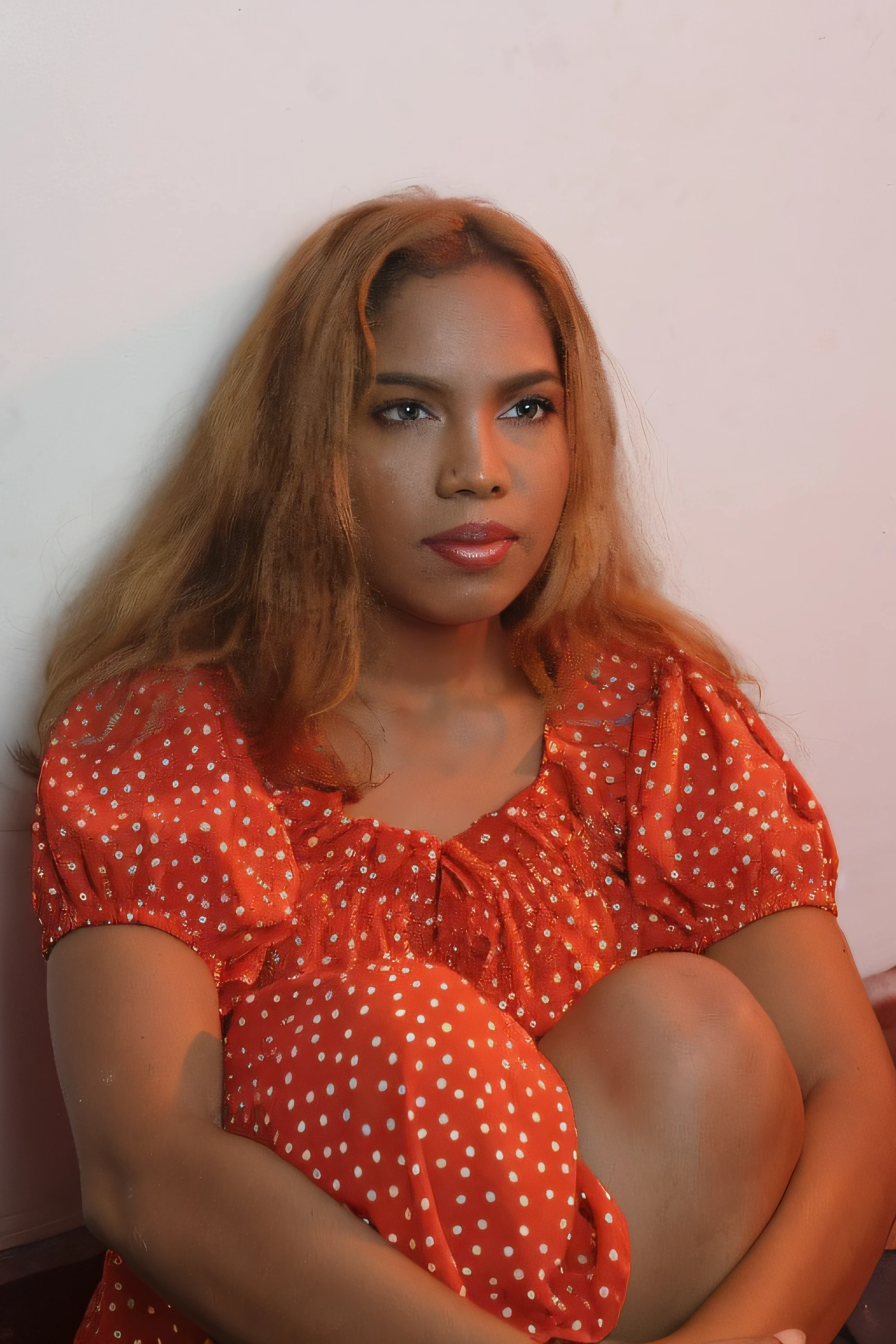 a woman sitting on the floor with her legs crossed, 30-year-old woman from cuba, photo of a black woman, malika favre, mid shot portrait, with brown skin, leaked photo, indian girl with brown skin, by Ramón Silva, photo shoot, wearing orange sundress, with curly red hair, glamour shot