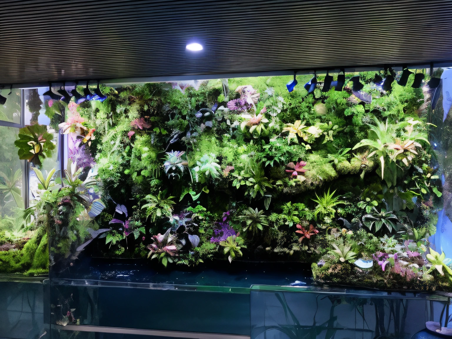 there is a large plant wall with many plants growing on it, water flows inside the terrarium, theophanic atmospheric vivarium, filled with plants and habitats, verdant plants green wall, vines wrap around the terrarium, verdant plant wall, lush gardens hanging, vertical gardens, vivarium, river with low hanging plants, terrarium lounge area