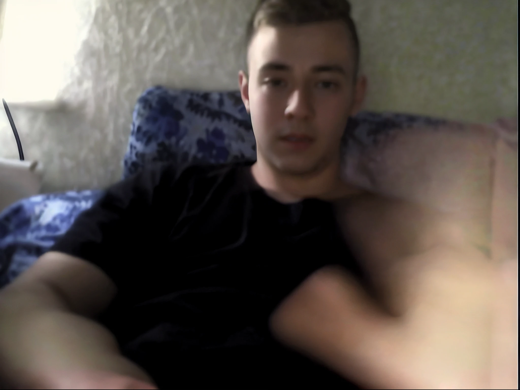there is a man sitting on a couch with his hand up, shot on webcam, webcam screenshot, webcam footage, webcam, around 1 , around 20 yo, on my bed, cute young man, low quality video, twink, very very low quality picture, very very low quality, low quality photo, he is about 20 years old | short