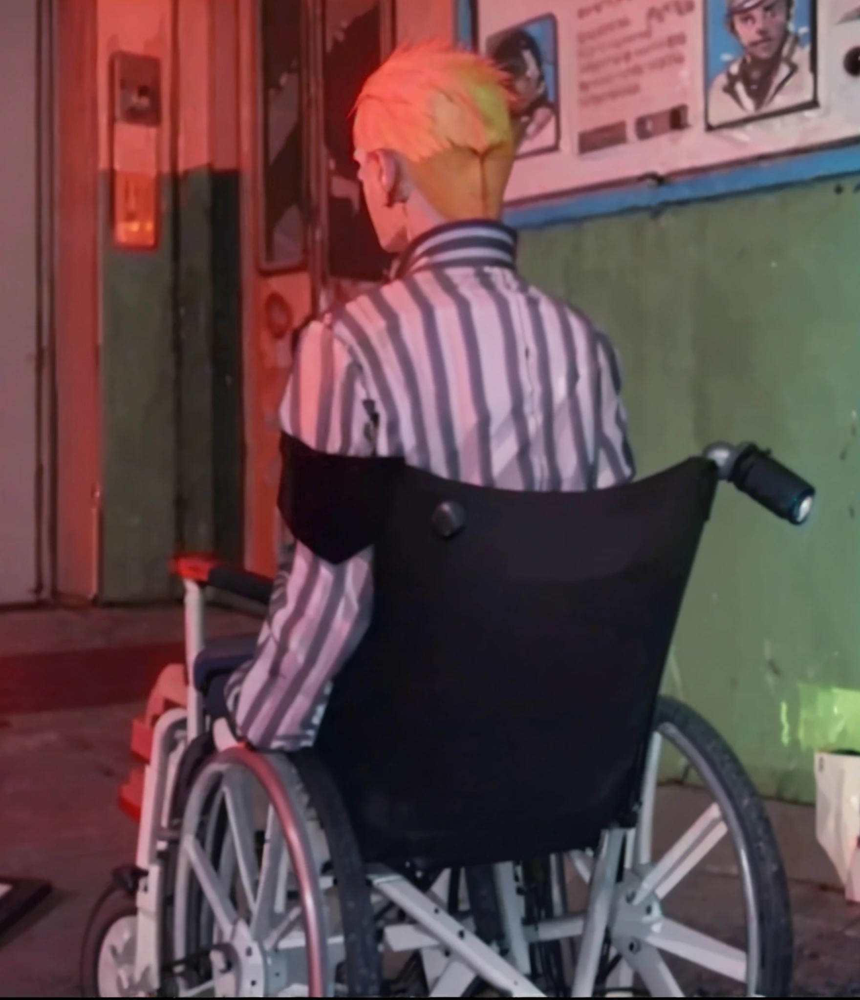 In front of the wall sat a man in a wheelchair, in wheelchair, cyberpunk dyed haircut, Die Antwoord music video, video still, vhs footage still, Travis Bickle has a mohawk, futuristic wheelchair, lil peep, still from a music video, wheelchair, broken wheelchair, vhs screencap, vulnerable, video game screenshot>