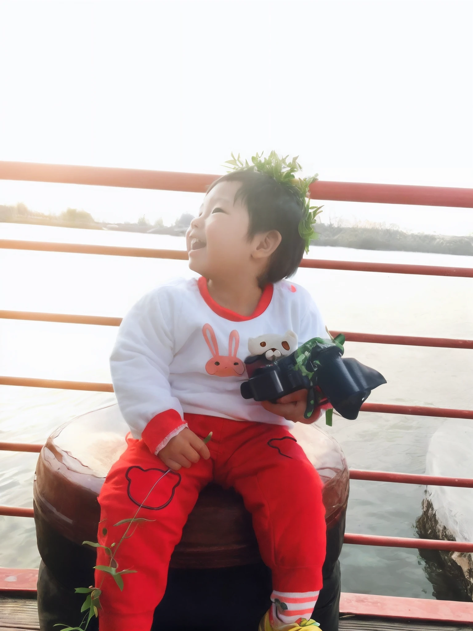 There was a small child sitting on a bench，holding a camera, Happy kids, she is happy, he is happy, 2 years old, very very happy!, Portrait image, river in front of him, joyful expressions, With a happy expression, Li Zixin, child, joy, expressing joy, she expressing joy, being delighted and cheerful, cheerfulness, Children