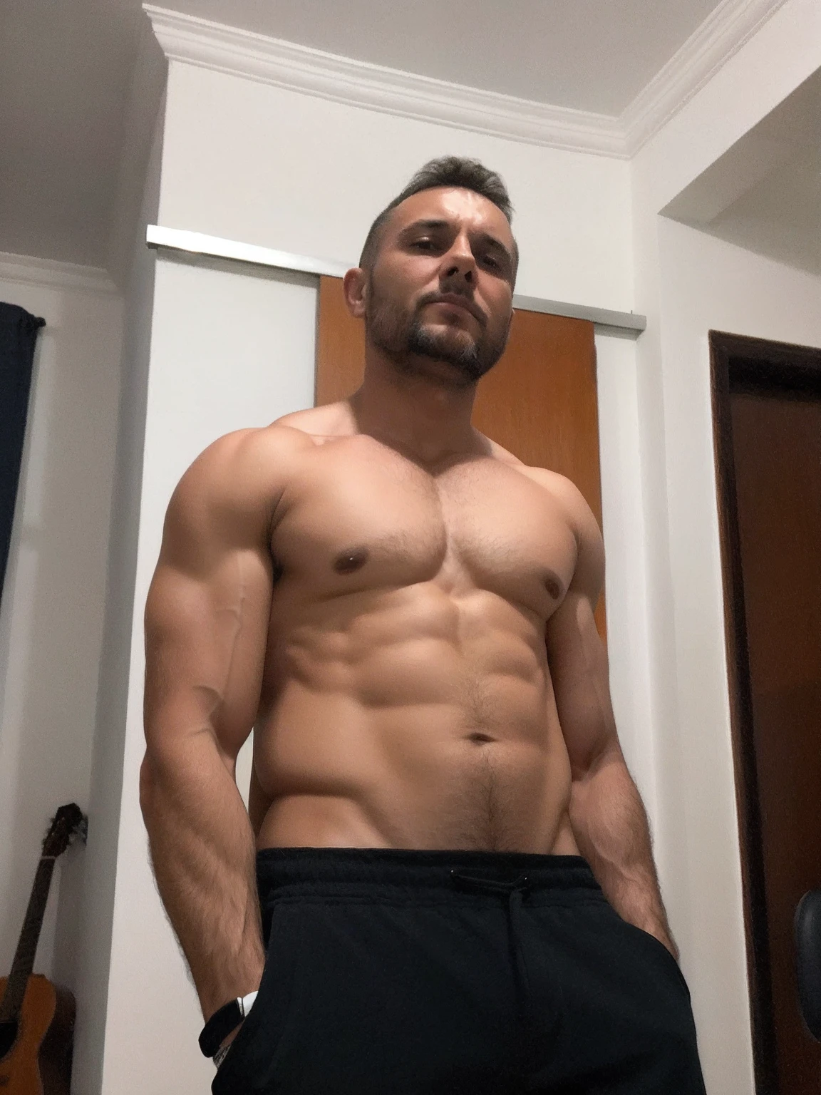 There's a man who's in a room with a guitar, 3 6 anos,homem de idade, bodybuilder