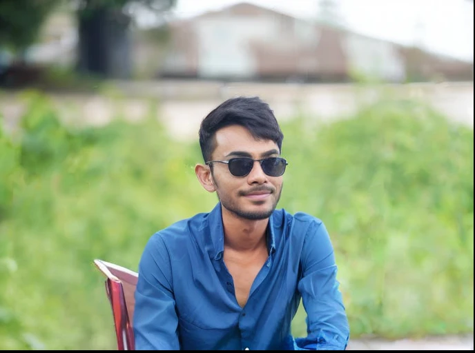 there is a man sitting on a bench with a blue shirt, candid picture, potrait, stylish pose, stunning photo, shot on sony a 7, portrait mode photo, portait image, selfie photo, portait photo, shot with sony alpha, candid photo, portait photo profile picture, with a cool pose, with accurate face, by Jan Rustem