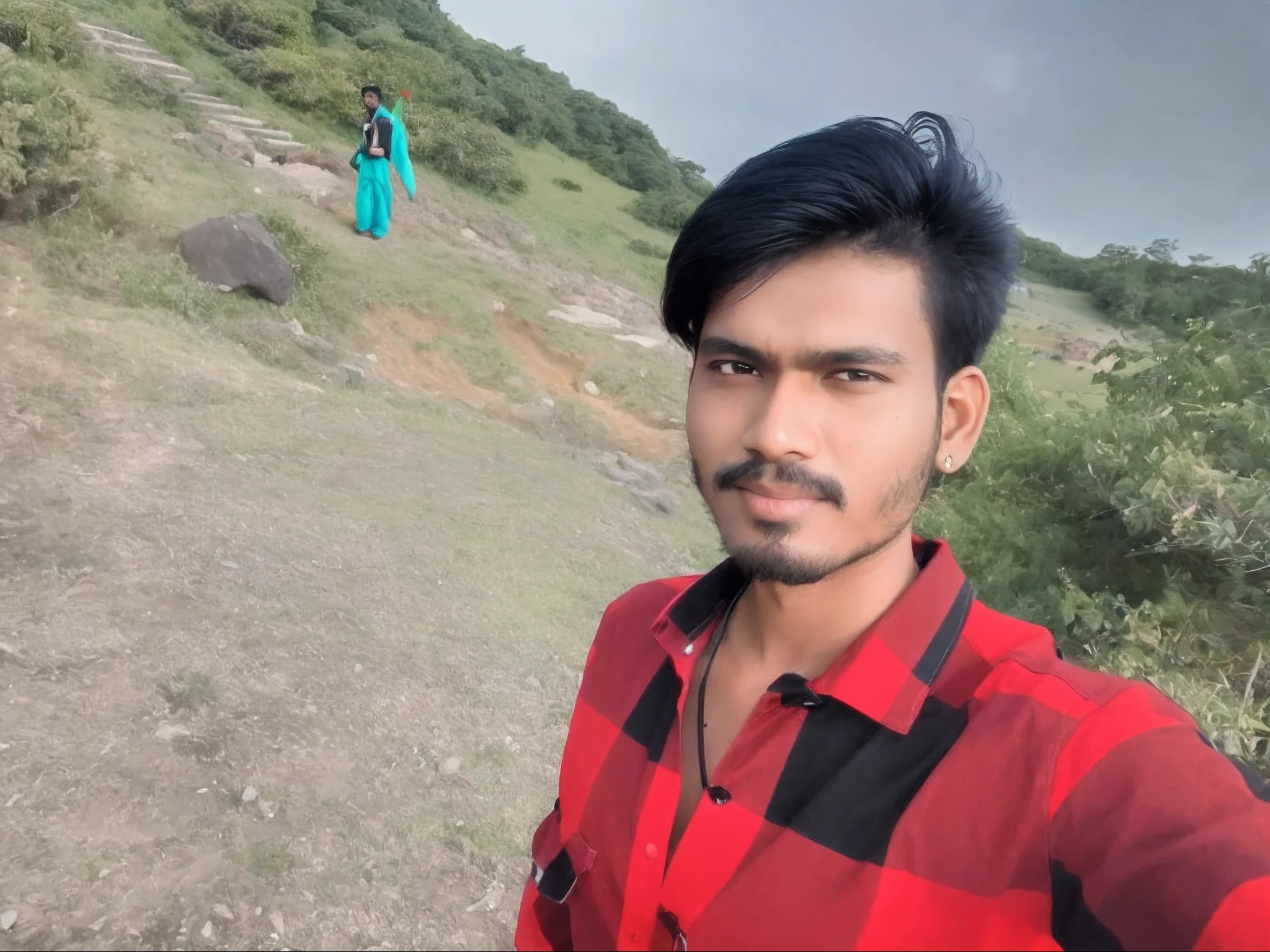 there is a man standing on a hill with a red and black shirt, 8k selfie photograph, very very low quality picture, amidst nature, ayan nag, vastayan, selfie!!!!! of a man, jayison devadas, very clear picture, very accurate photo, selfie photo, by Thota Vaikuntham, vinayak, candid picture, selfie photography