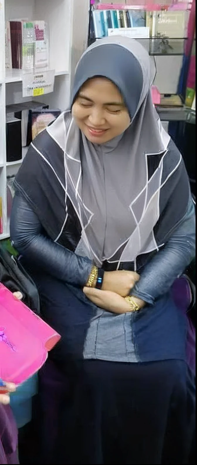 woman in a hijab sitting on a chair with a book, naked, busty breast, sexy legs