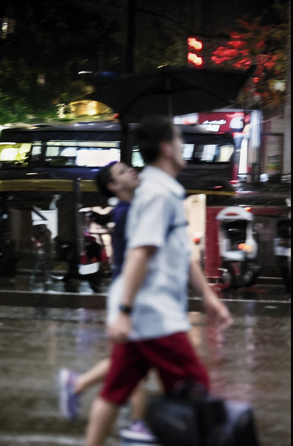 Pedestrians carrying luggage walking on city streets in the rain, People are out of focus, extreme motion blur on people, The movement of people walking is blurred, Severe bokeh and blur, 8K 50mm ISO 10, severe out of focus, people in street, busy wet street at night, Blurred and sharp focus, blurry photo, people walking on the street
