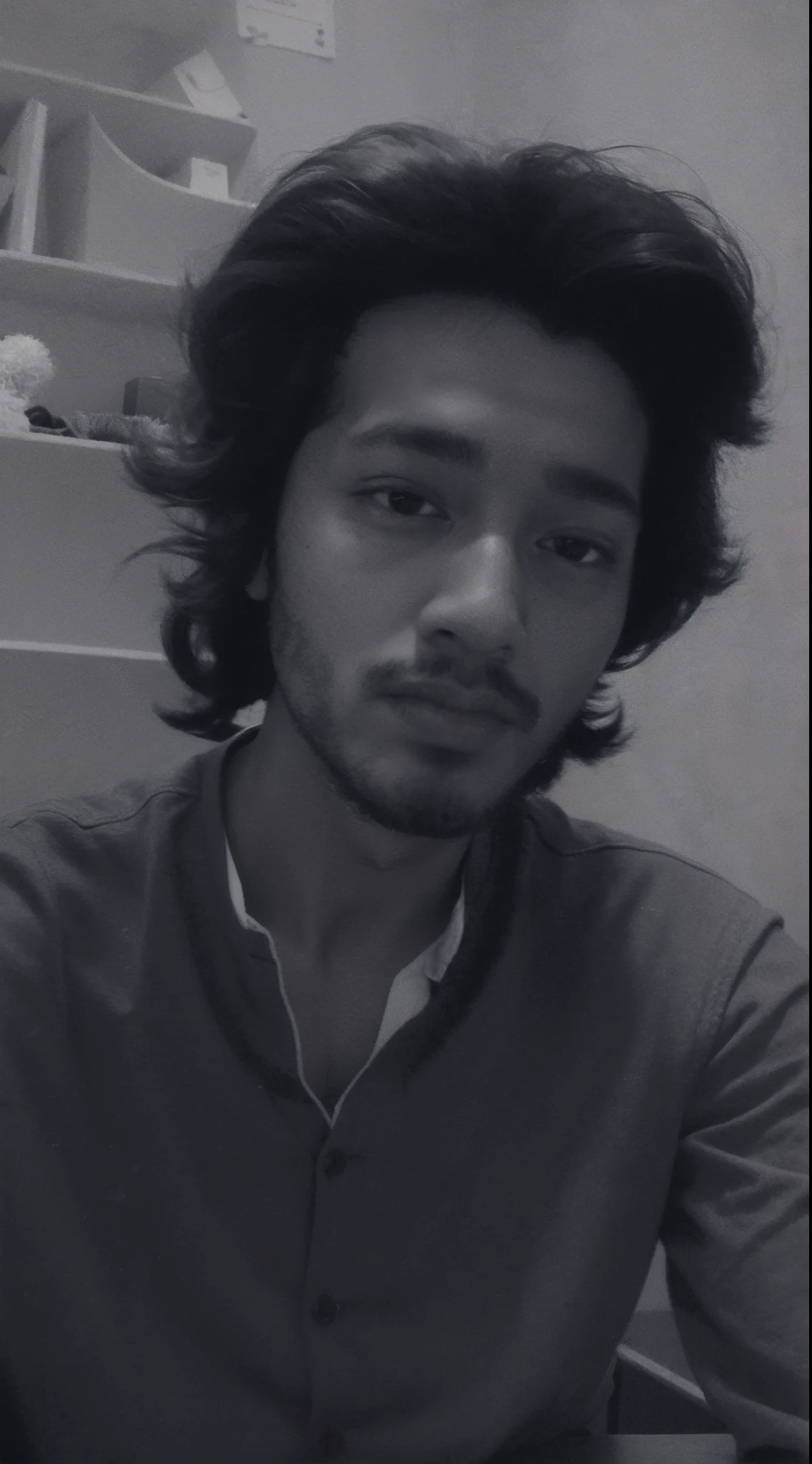 arafed man with a beard and a shirt sitting at a table, desaturated!!, black and white picture, desaturated!, around 1 9 years old, riyahd cassiem, mohamed chahin, khyzyl saleem, very very low quality picture, inspired by Bikash Bhattacharjee, ash thorp khyzyl saleem, old picture