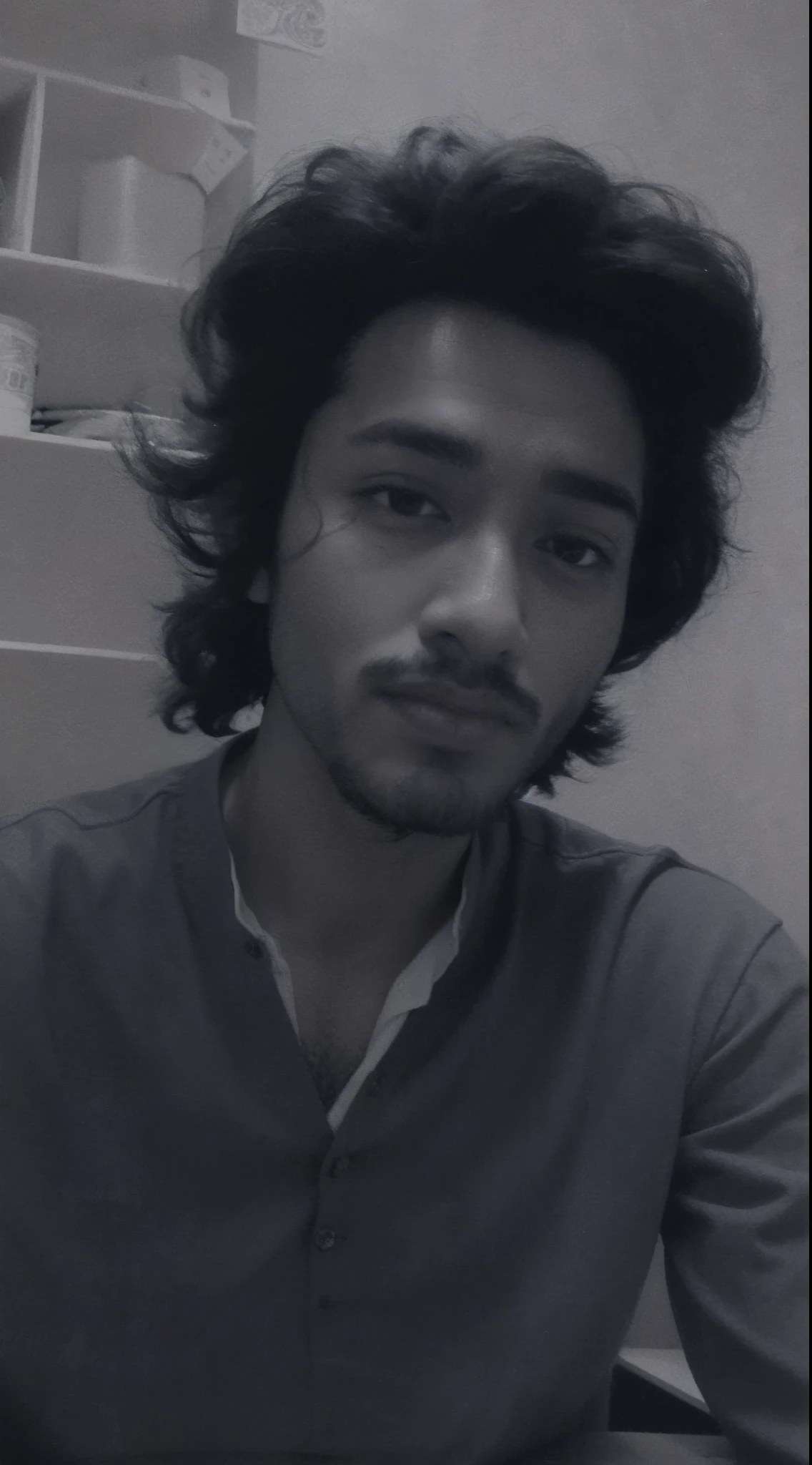 arafed man with a beard and a shirt sitting at a table, desaturated!!, black and white picture, desaturated!, around 1 9 , riyahd cassiem, mohamed chahin, khyzyl saleem, very very low quality picture, inspired by Bikash Bhattacharjee, ash thorp khyzyl saleem, old picture