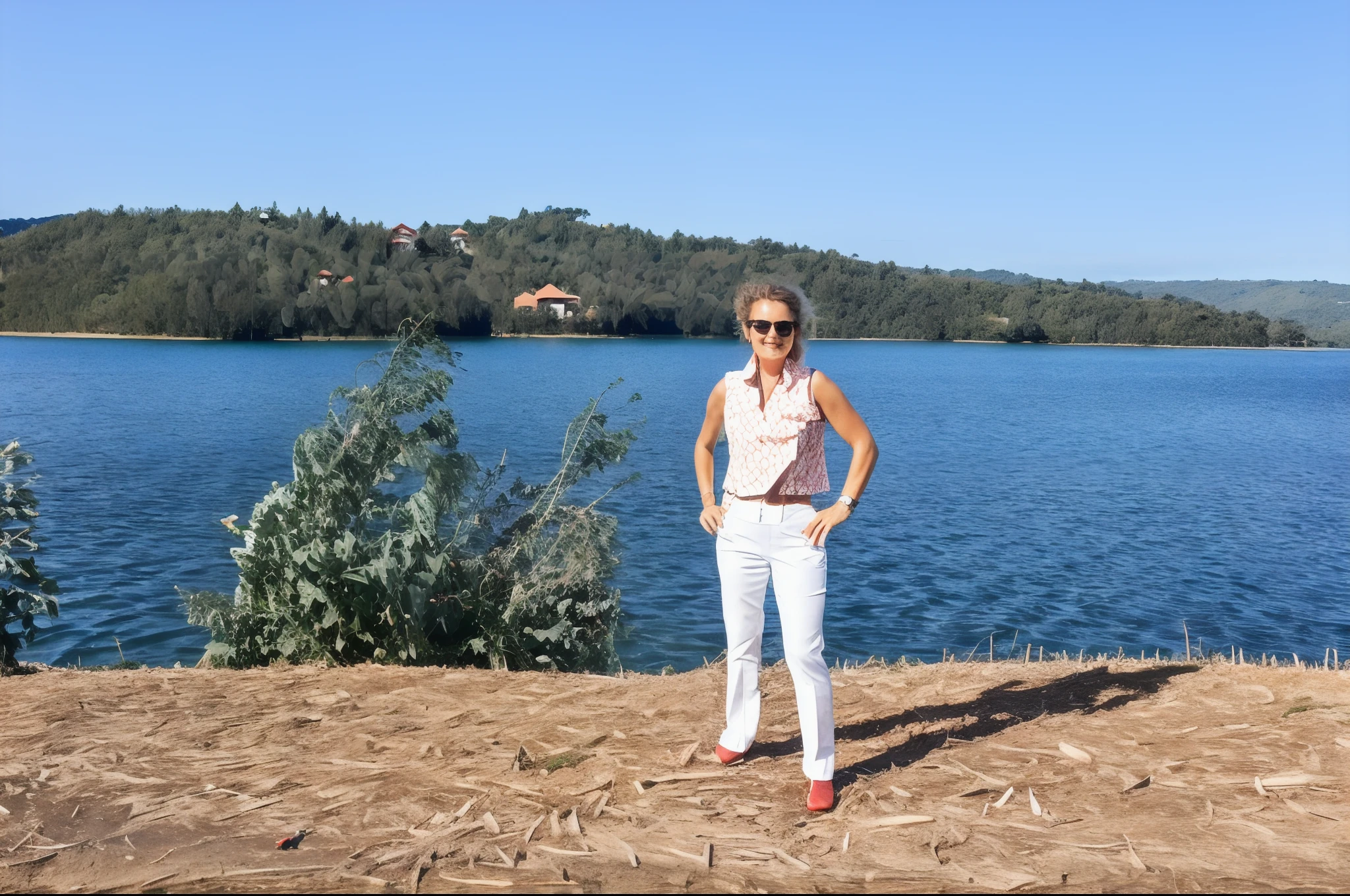 There is a woman standing on a hill overlooking a lake, perto de um lago, Lago ao fundo, no lago, standing in a lake, vista para o lago, em um lago, tiro de corpo inteiro, tiro de corpo inteiro distante, traje : blue pants and red vest, one dog,