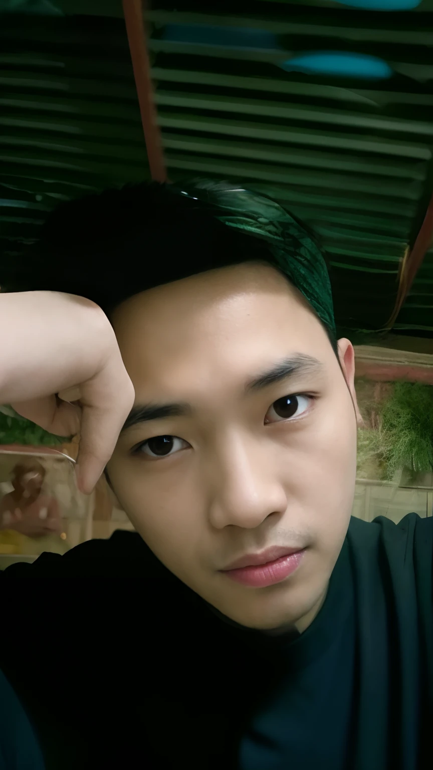 there is a man that is holding a cell phone up to his ear, 2 s old, 2 8 year 2 3 years old,ears old, 2 2 yld, with accurae, showing forehead, 2 4 years old, asian male, thawaanee, 21 years old, good looking face, forehead only