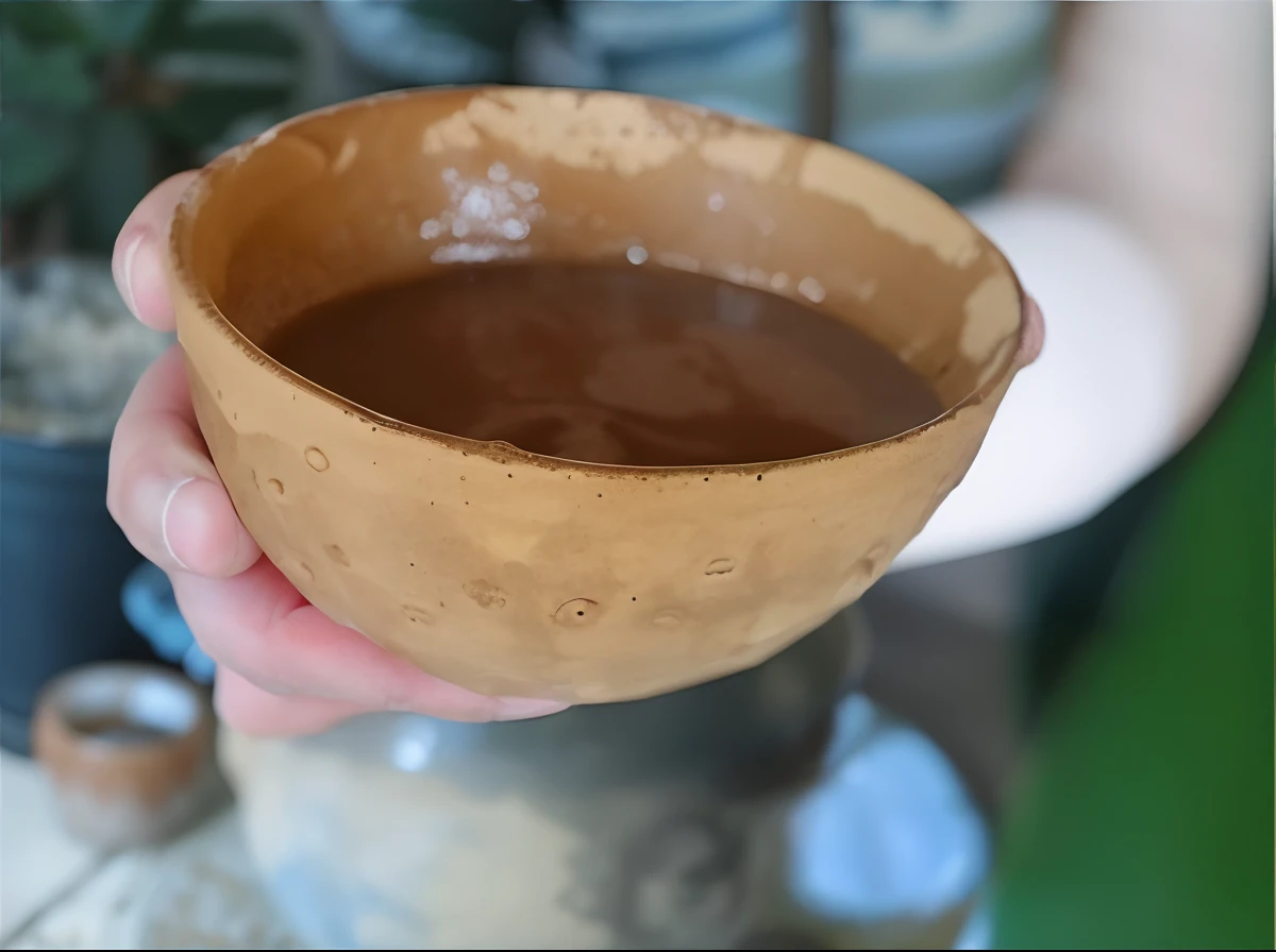 someone holding a brown bowl of Ayahuasca in their hand, ayahuasca, .jar, alchemist still made of clay, chocolate, the sacred cup of understading, the ayahuasca spirit, ayahuasca ceremony, copos de madeira, tigela, argila molhada, colombiano, Larapi, argila, cor da pele da canela, ceramic, coffee shop, copo de cobre, sopa