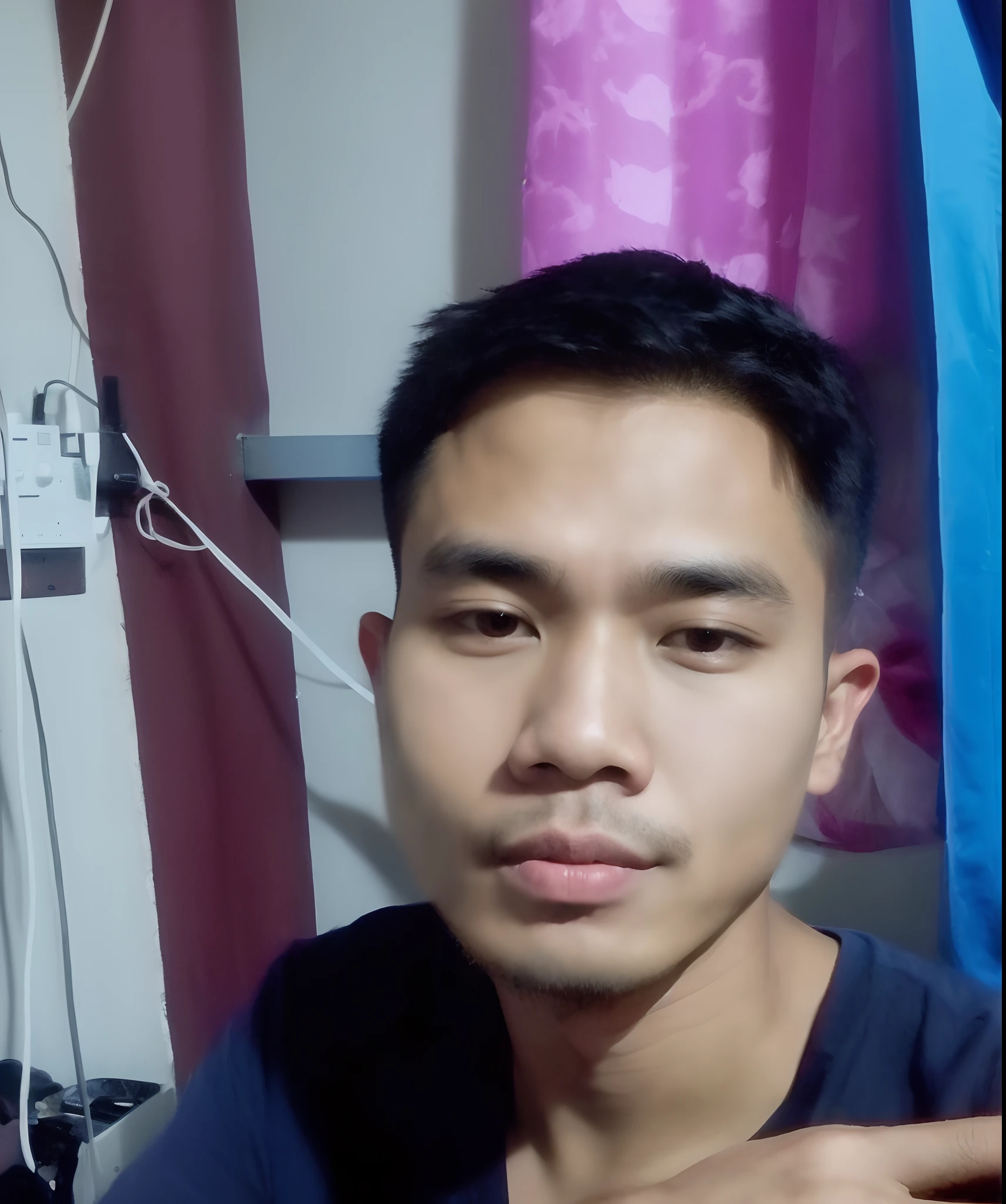 there is a man sitting in a room with a blue curtain, potrait, south east asian with round face, with accurate face, 2 7 years old, ayan nag, asian male, 4 0 years old man, picture, ramil sunga, 2 8 years old, 2 3 years old, thawan duchanee, 2 4 - year - old man