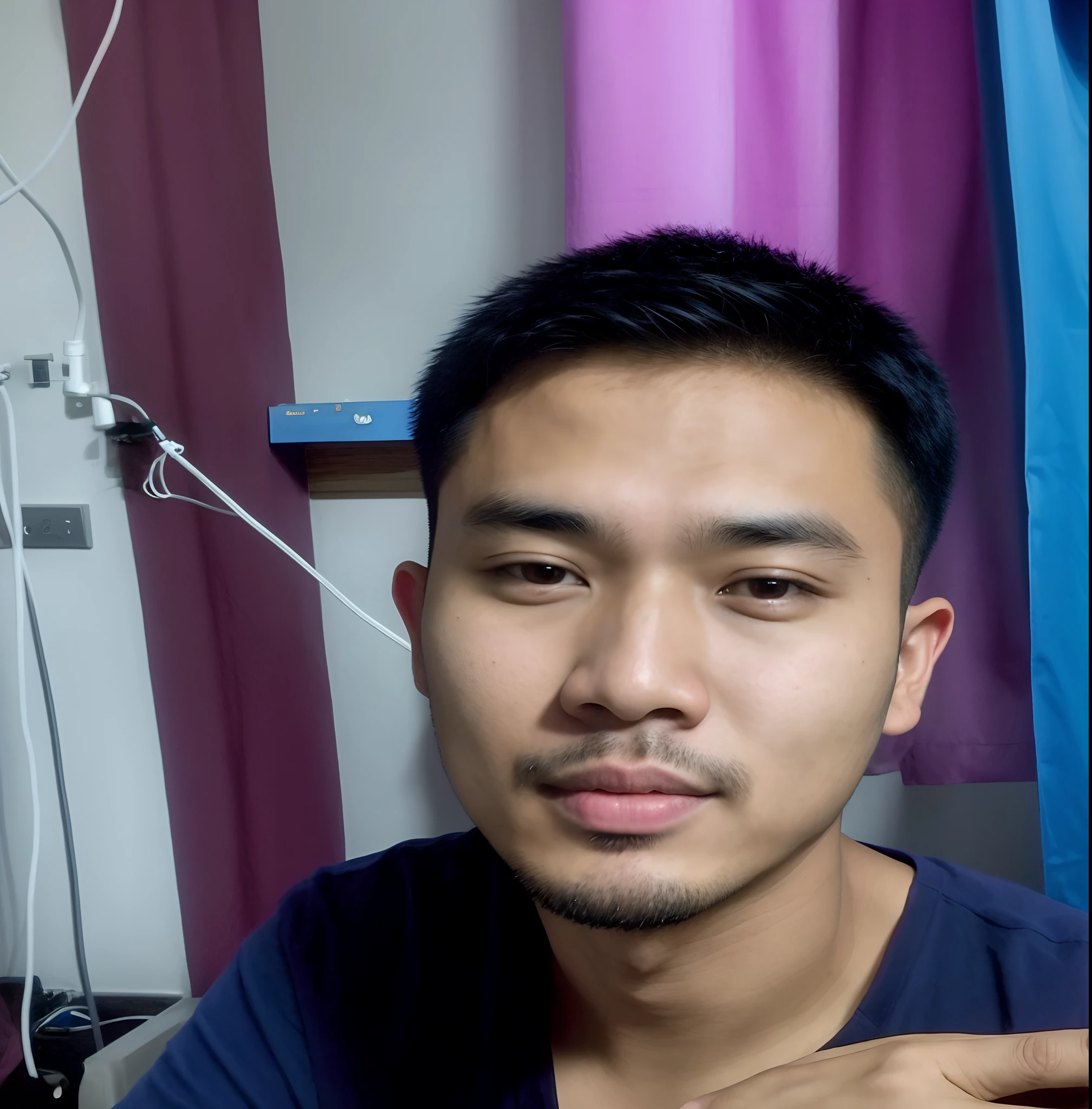 there is a man sitting in a room with a blue curtain, potrait, south east asian with round face, with accurate face, 2 7 years old, ayan nag, asian male, 4 0 years old man, picture, ramil sunga, 2 8 years old, 2 3 years old, thawan duchanee, 2 4 - year - old man