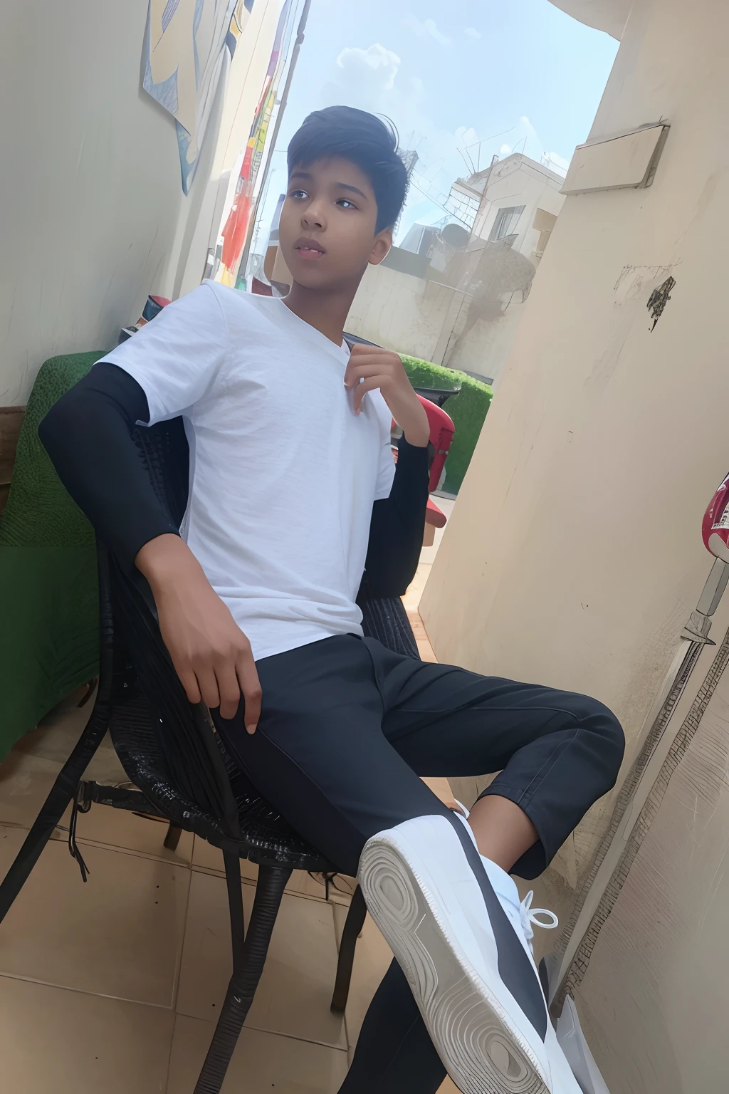 A boy sitting on a chair and staring at a girl