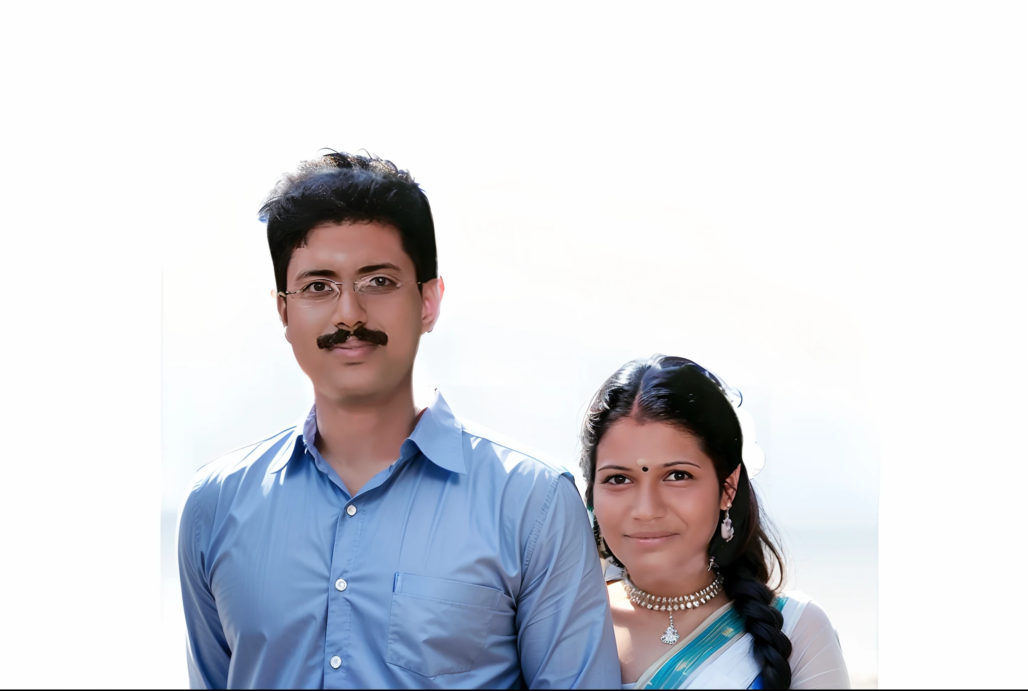A guy wearing a collar white shirt,a girl wearing a blue saree,as a background a Kerala temple