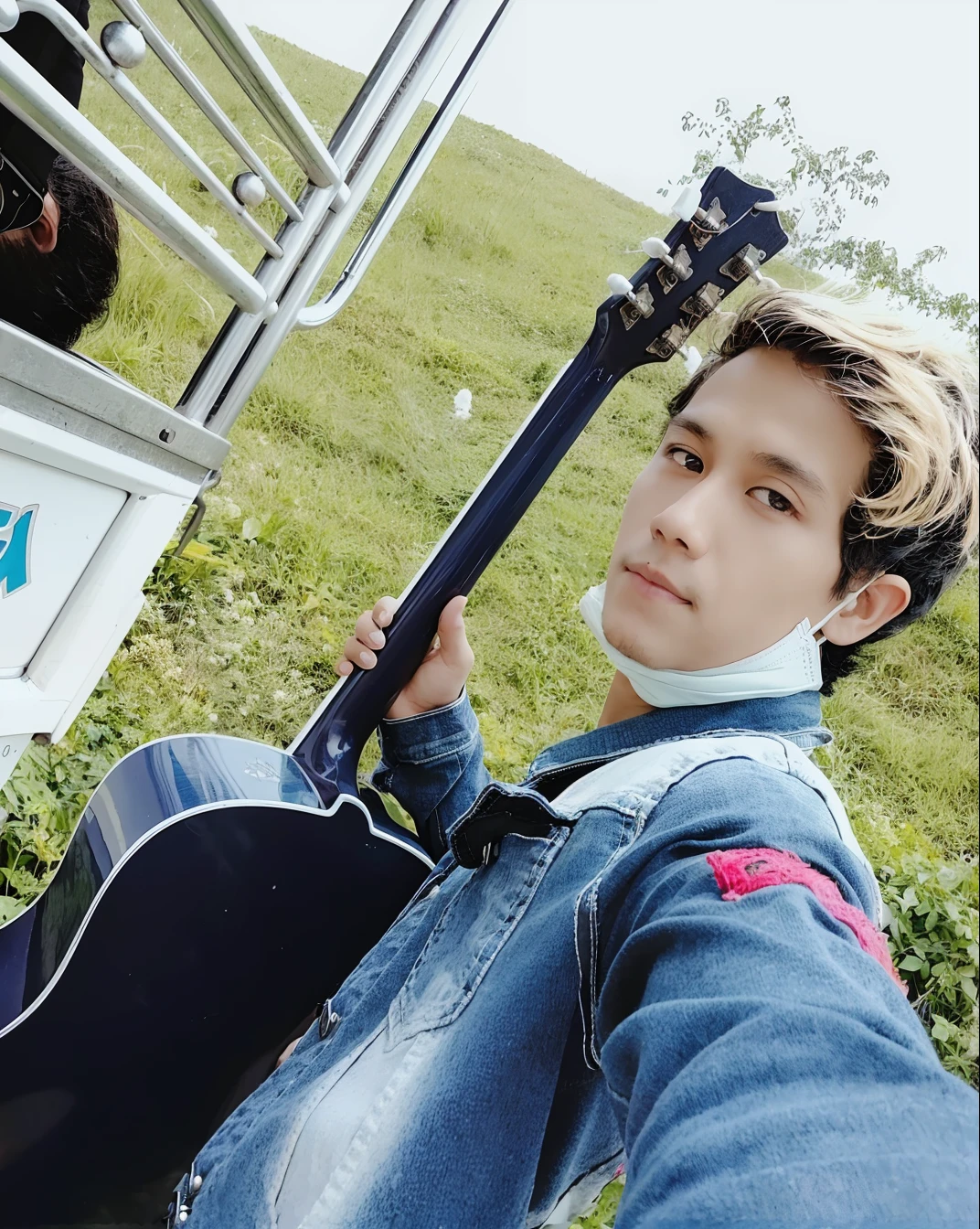 there is a man holding a guitar in his hand while sitting in the grass, ash thorp khyzyl saleem, ayan nag, profile pic, mateus 9 5, ramil sunga, thawan duchanee, album photo, high quality upload, khyzyl saleem, carrying a guitar, new song, nivanh chanthara