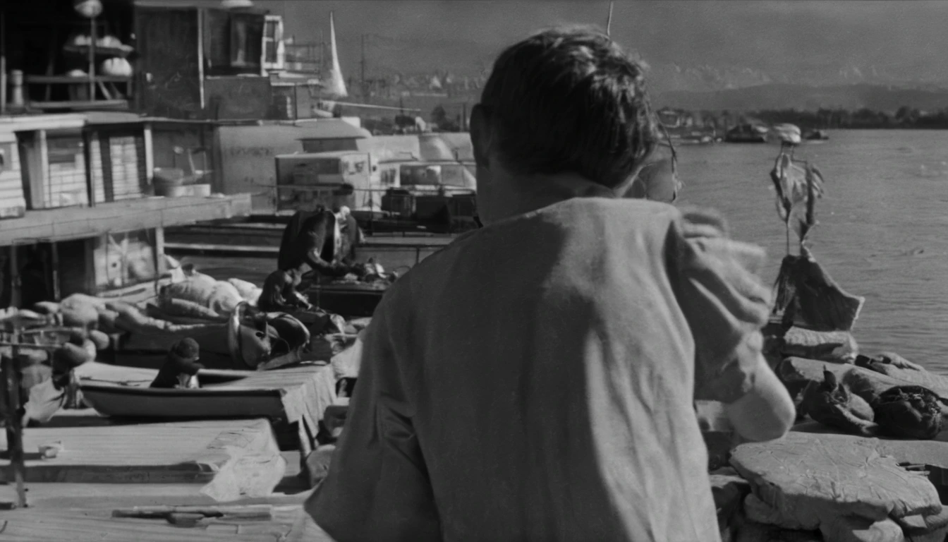an old black and white photo of a poor white 12yo boy stand up holding box of nuts and selling nuts and waving with his hands in algeria boat port waving with his hand, dirty clouths ,1948, real-life photograph, french architecture, provia, security agent, vignette, small of people, real, large frame