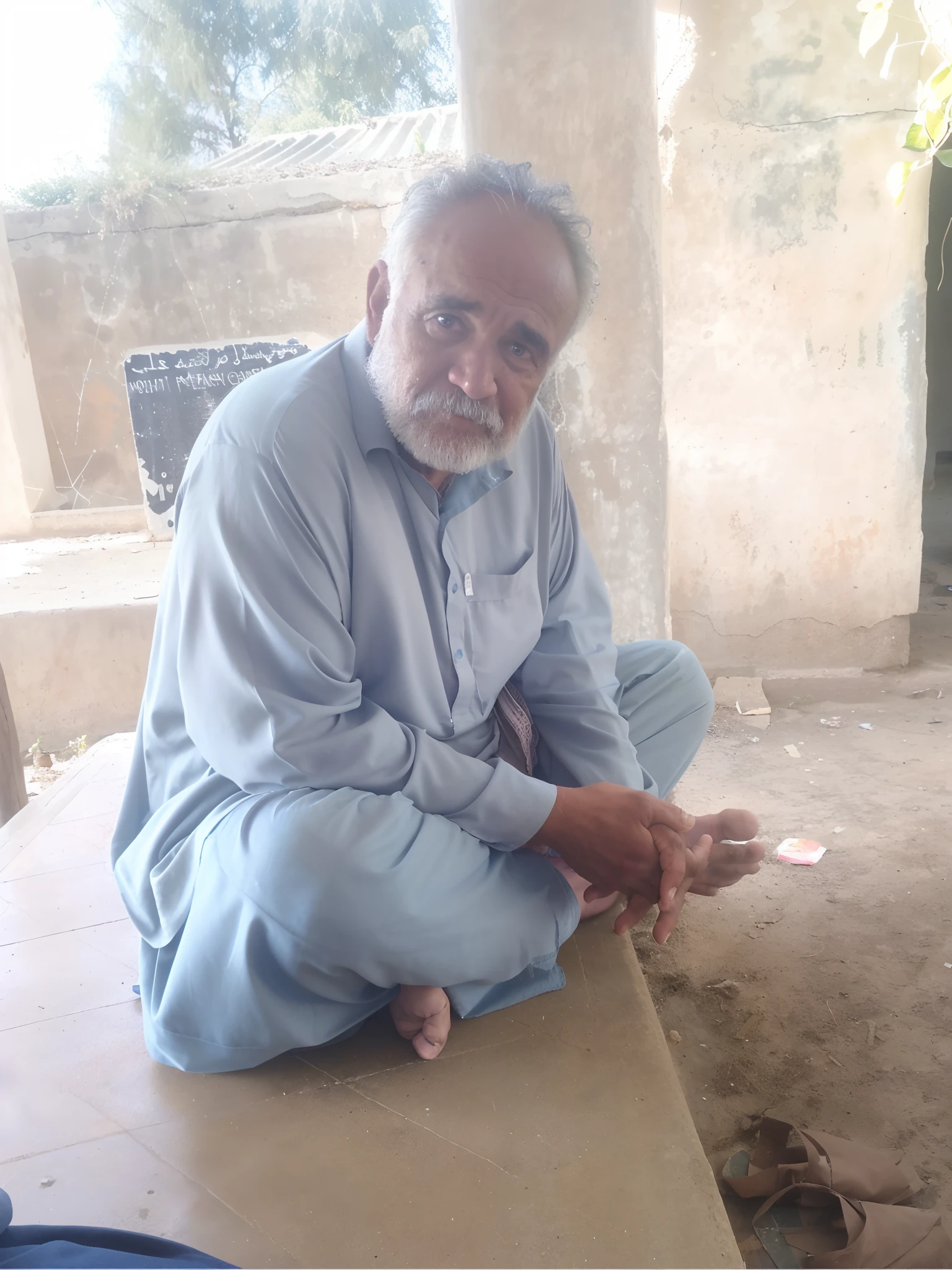 there is a man sitting on a cement bench with a piece of paper, holy man looking at ground, he is about 60 years old, he is about 6 0 years old, he is about 7 0 years old, he is about 8 0 years old, selling his wares, a very sad man, a photo of a man, very very low quality picture