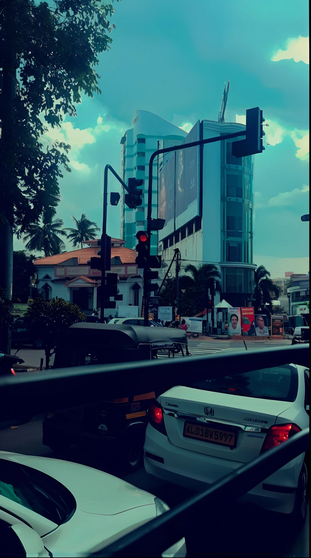 cars are stopped at a traffic light on a busy city street, colombo sri lankan city street, intersection, traffic in background, busy streets, in busy city, view from the streets, captured on iphone, street level view, in city street, in the middle of the city, very busy place, traffic light on, busy city, driving through the city, busy street, 8k
