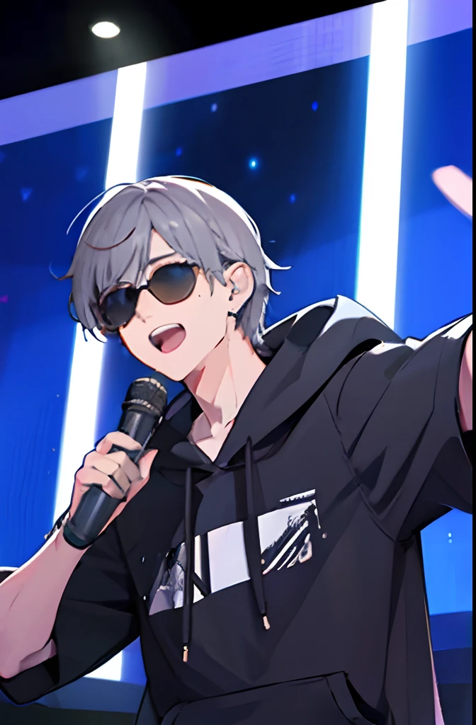 a boy with grey hair singing on stage with light show, wearing a hoodie and sunglasses while having a head mic