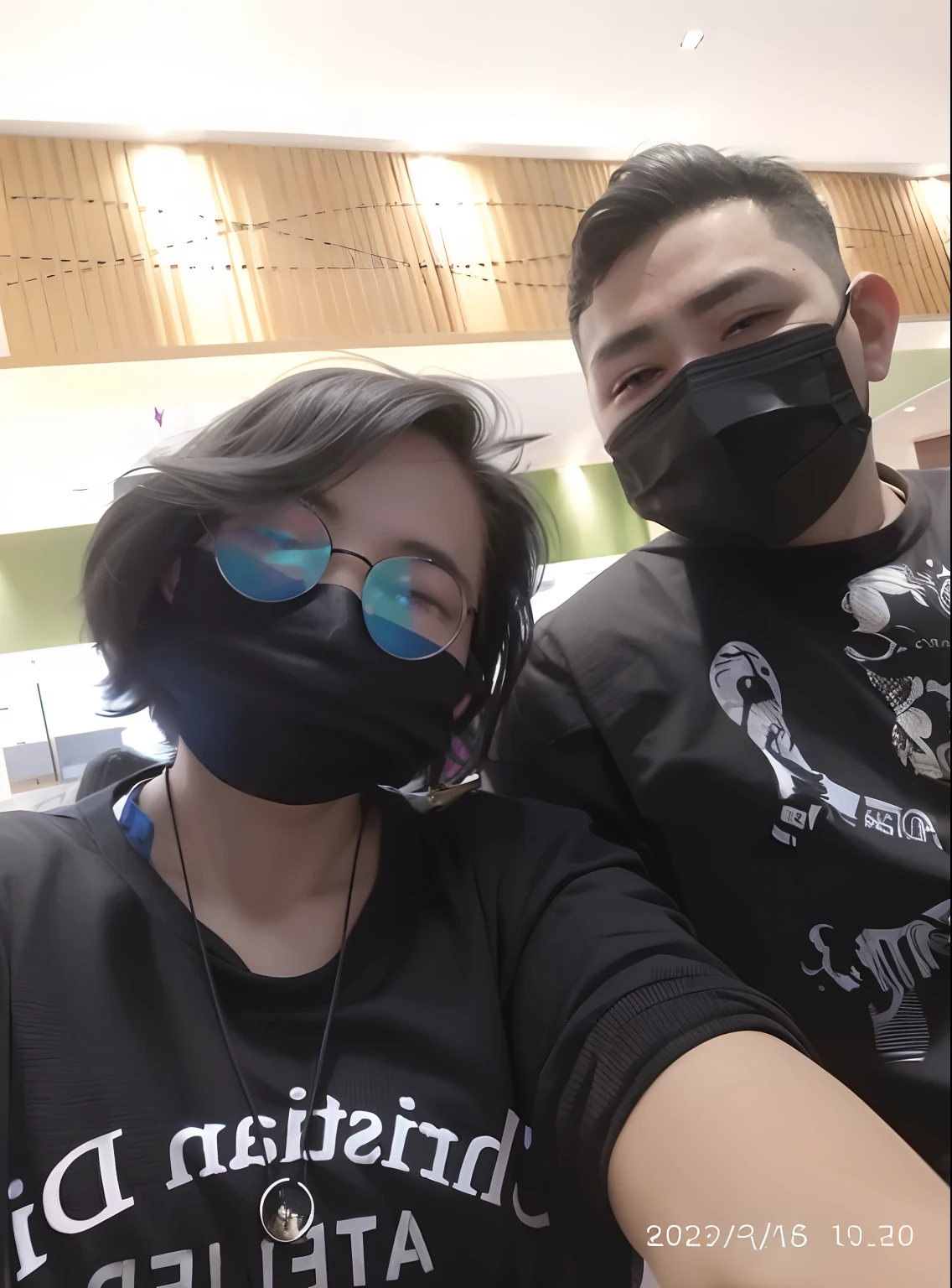 they are wearing masks and sitting on a couch, wearing all black mempo mask, wearing mask, at a mall, mall goth, in a mall, wearing facemask, wearing facemask and sunglasses, 8k selfie photograph, wearing black tshirt, back to us, with black, with wart, hidari and vlop, wearing a mask, selfie, okumura togyu inspired.