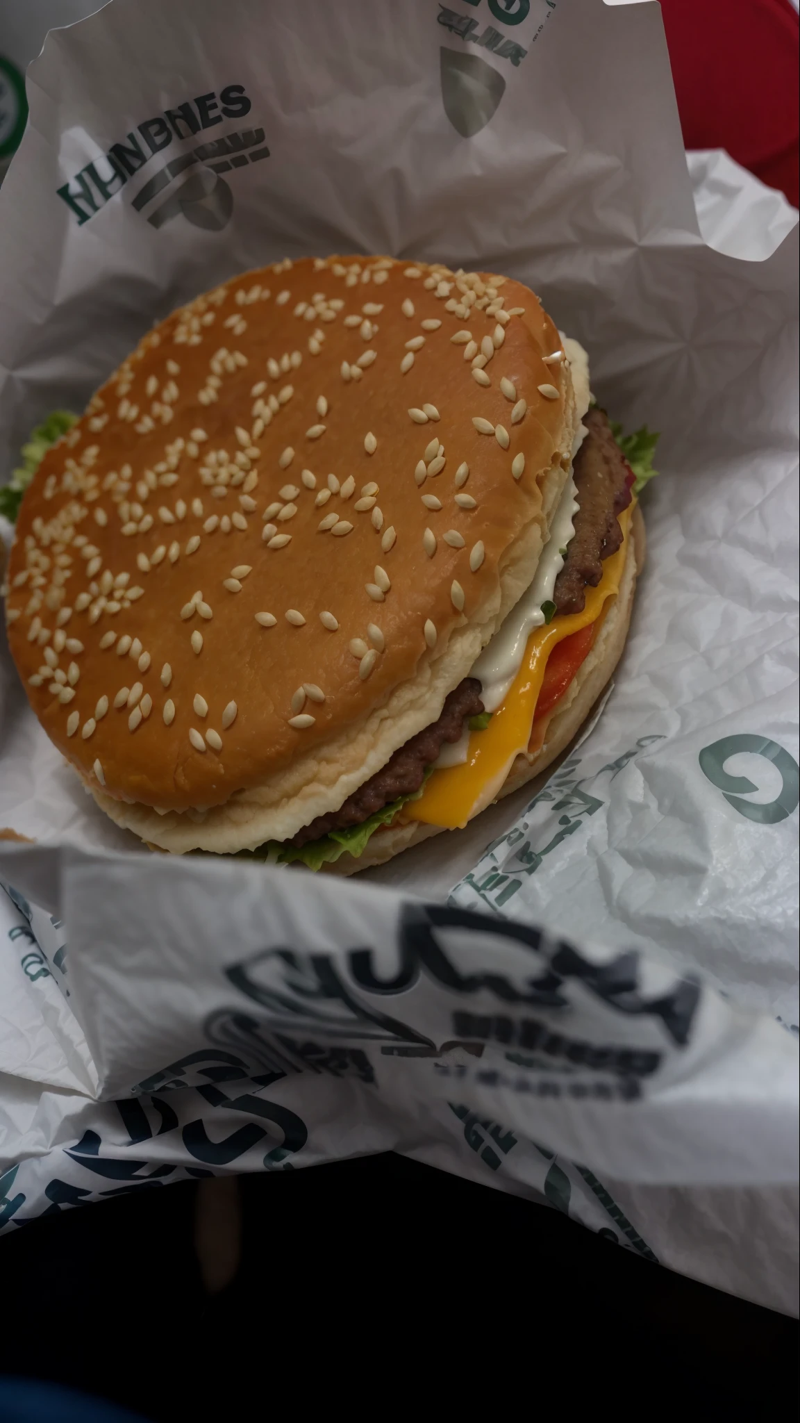 a closeup of a burger with cheese and lettuce in a wrapper, fast food review, cheeseburguer, big juicy burger, Macs grandes, burger, burger, Delicious burger with sesame seeds, ❤🔥🍄🌪, Burguer King, Wrapper McDonalds na mesa, Servindo Big Macs, Mcdonald, comer dentro do McDonalds, hamburgers, muito granulado