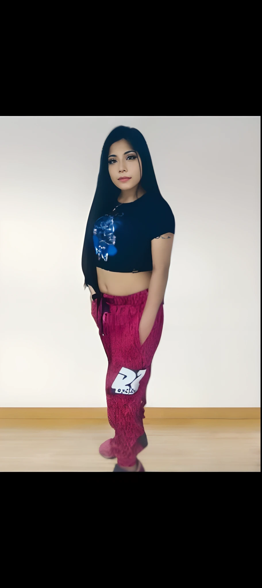 A native American girl, wearing a black Metallica T-shirt and shorts. She has braids with feathers in it