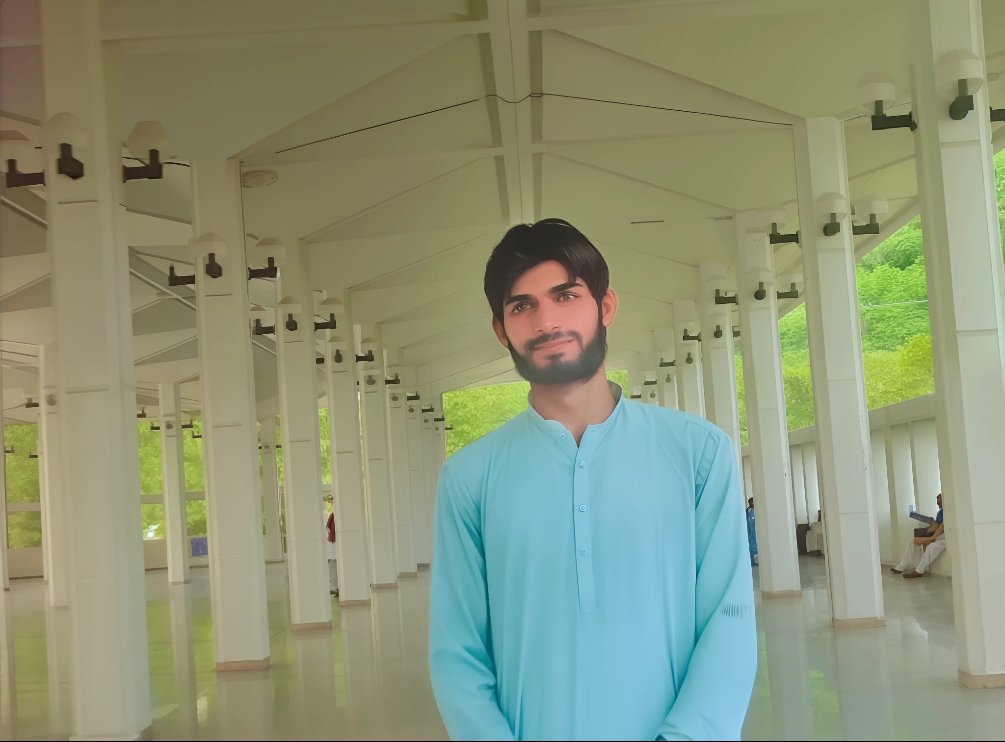 there is a man standing in a building with a blue outfit, he is in a mosque, handsome man, at college, wearing a kurta, kyza saleem, very very low quality picture, very clear picture, khyzyl saleem, taken with the best dlsr camera, full body photogenic shot, in a scenic background, wearing traditional garb