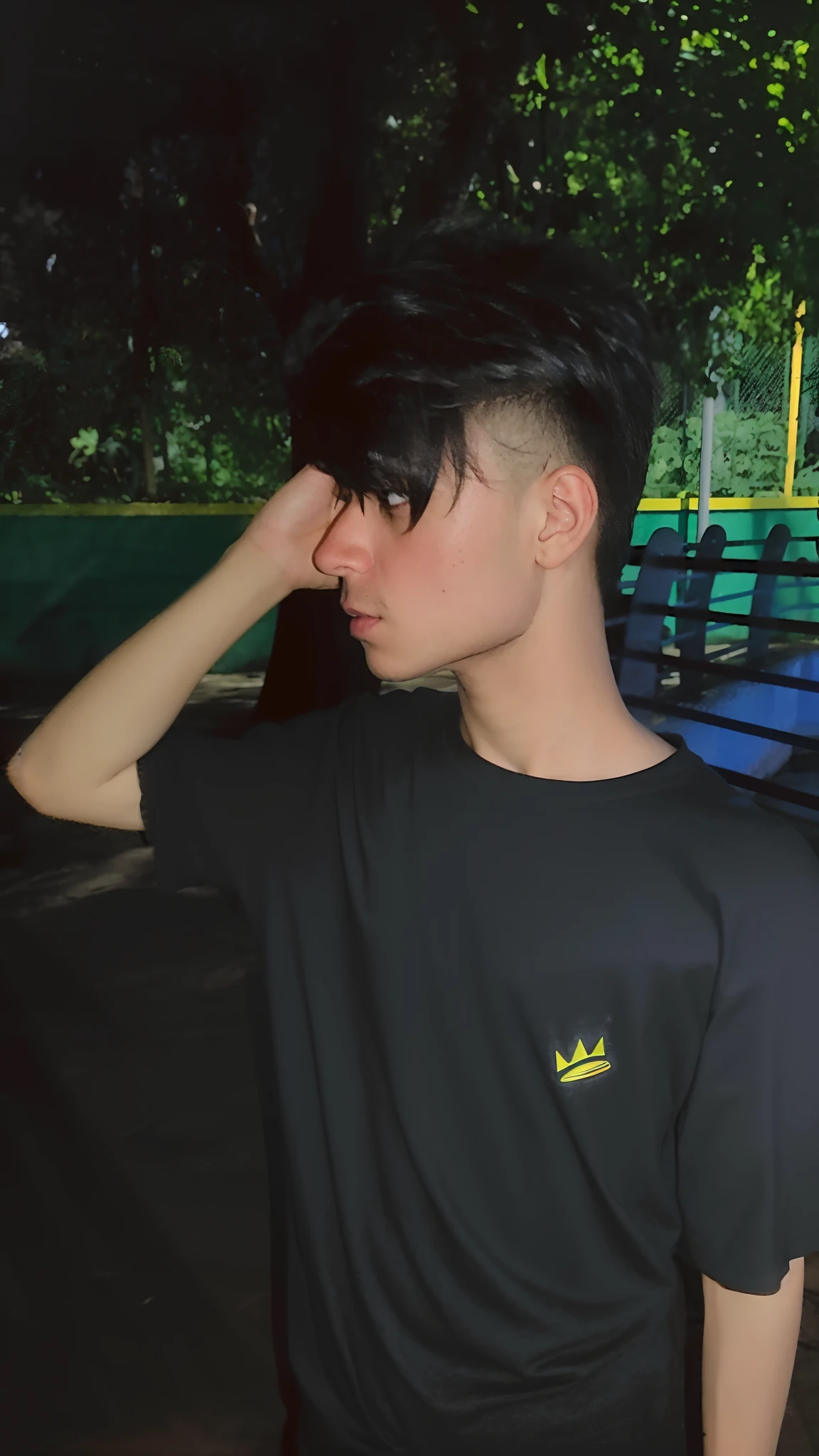 there is a man that is standing in the dark with a skateboard, with crown, wearing black tshirt, man with a crown, he is wearing a black t-shirt, black crown, with a crown, in tshirt, trending on r/streetwear, smooth in _ the background, wearing crown, with trident and crown, mid shot portrait, black t shirt