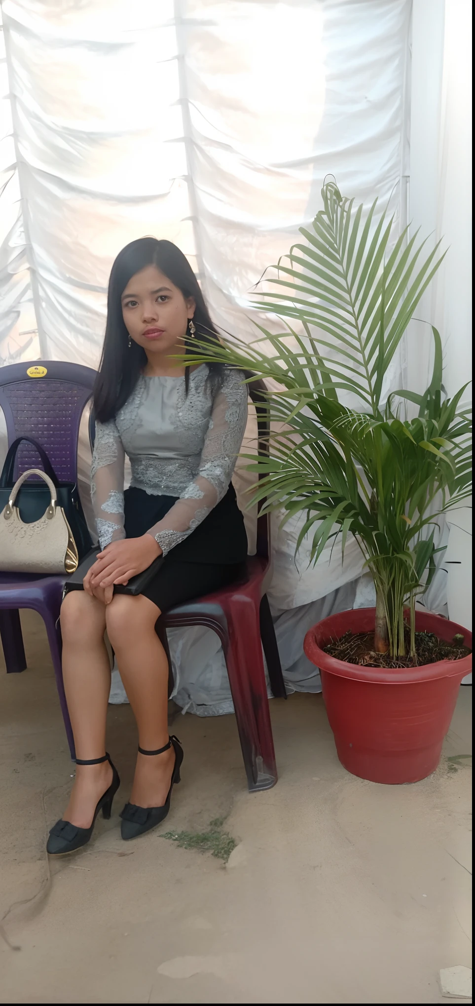 there is a woman sitting on a chair next to a potted plant, photo taken in 2 0 2 0, indoor picture, candid picture, full body picture, she is about 1 , she is about 2 0 years old, she is about 20 years old, around 1 9 years oldold, 3 0 years old woman