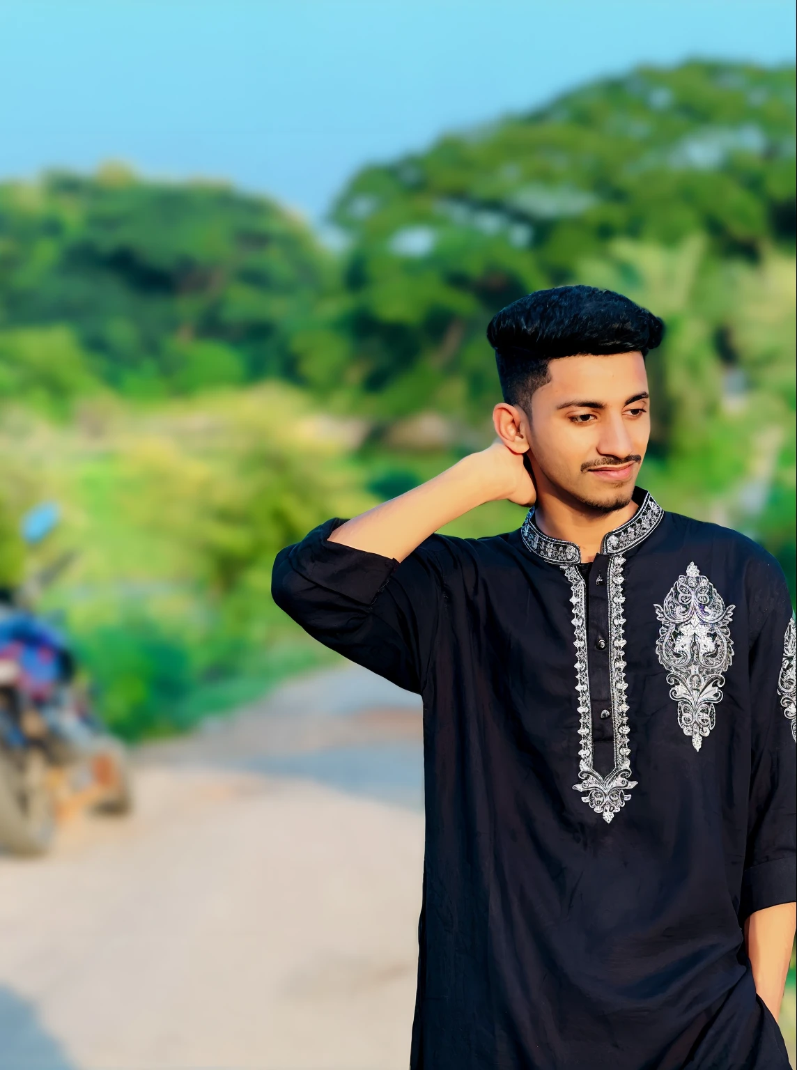 arafed man in a black shirt and white pants standing on a dirt road, wearing a kurta, wearing a silk kurta, assamese aesthetic, drake the rapper wearing a kurta, indian style, wearing an elegant tribal outfit, mohamed chahin style, kyza saleem, wearing an old tunic, traditional clothes, desi, wearing traditional garb