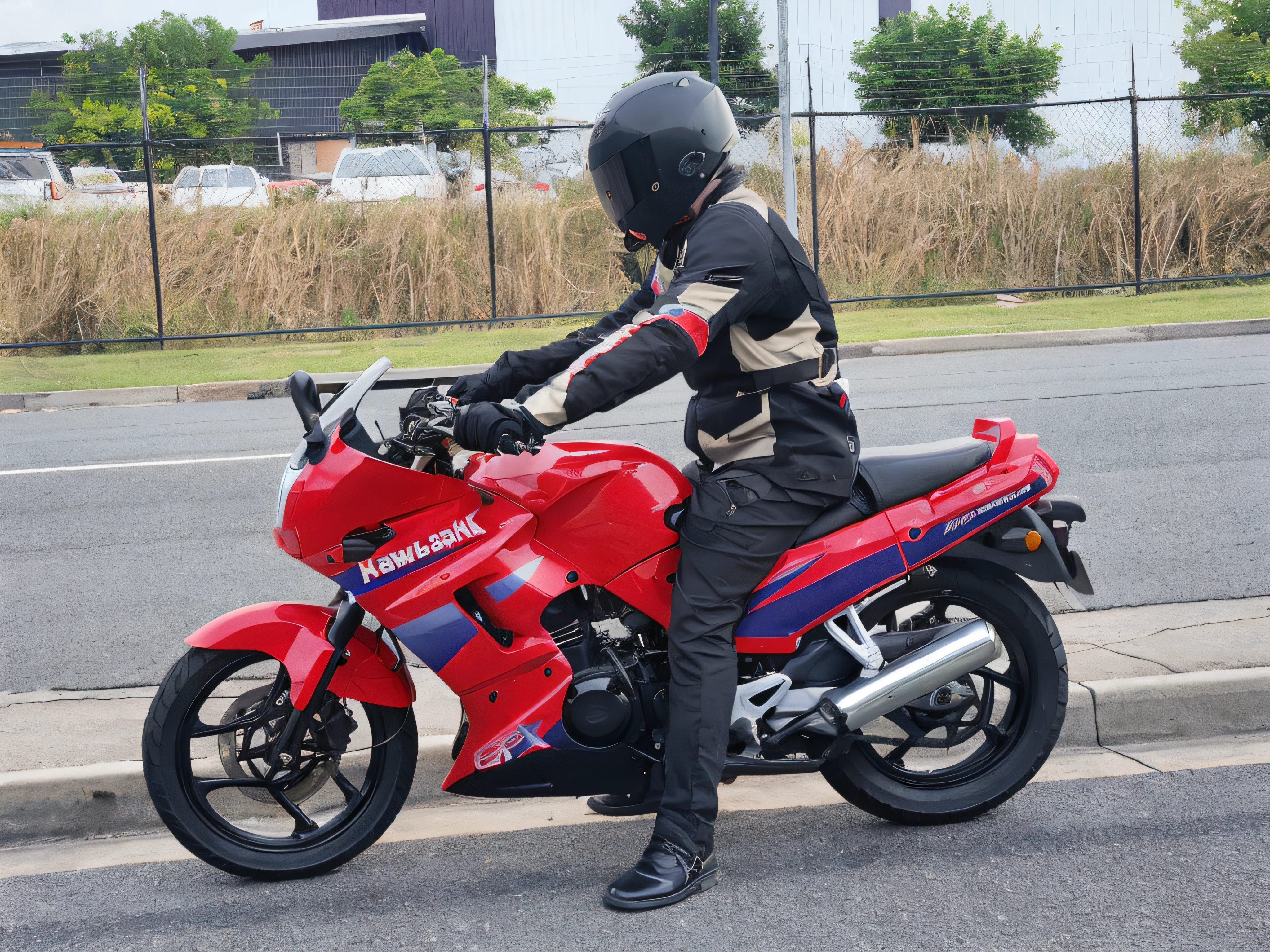 motor bike, person riding, hands on the handle of the bike, helmet with dark tinted screen. behind a factory. nice black shoes, nice tyres. smoke is coming out of the exhaus